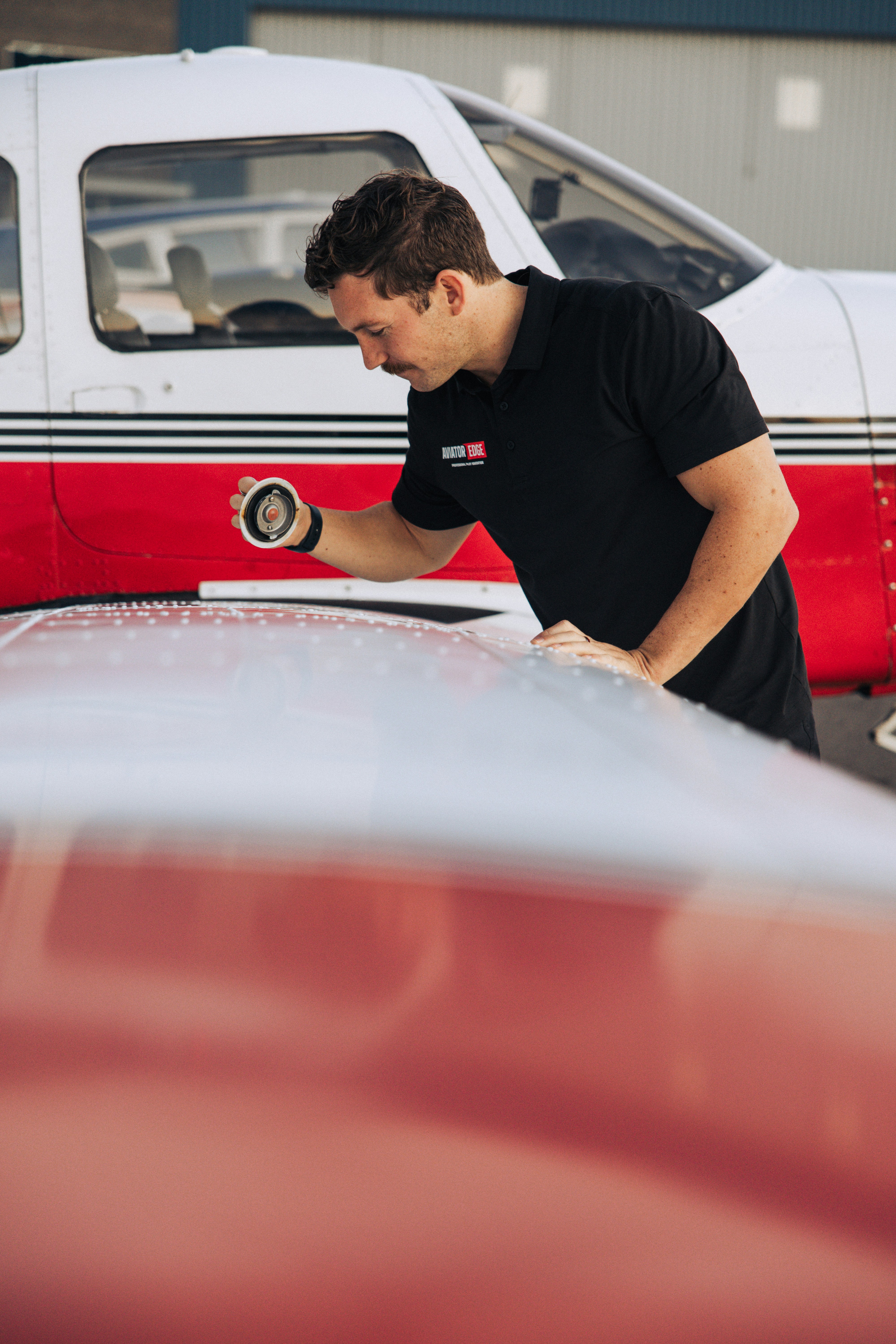 Mechanic inspecting a small airplane wing