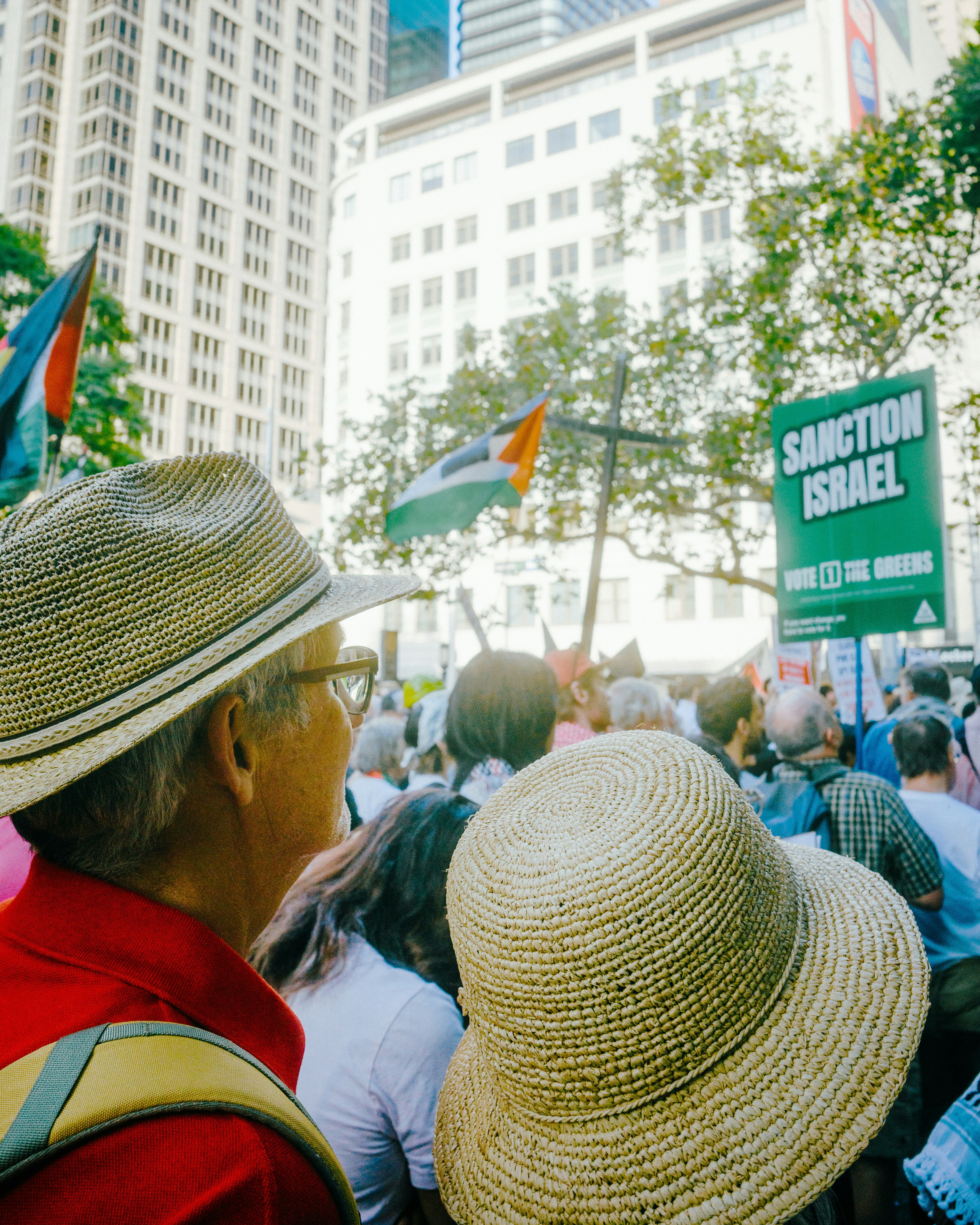 People at a protest with "sanction israel" sign.