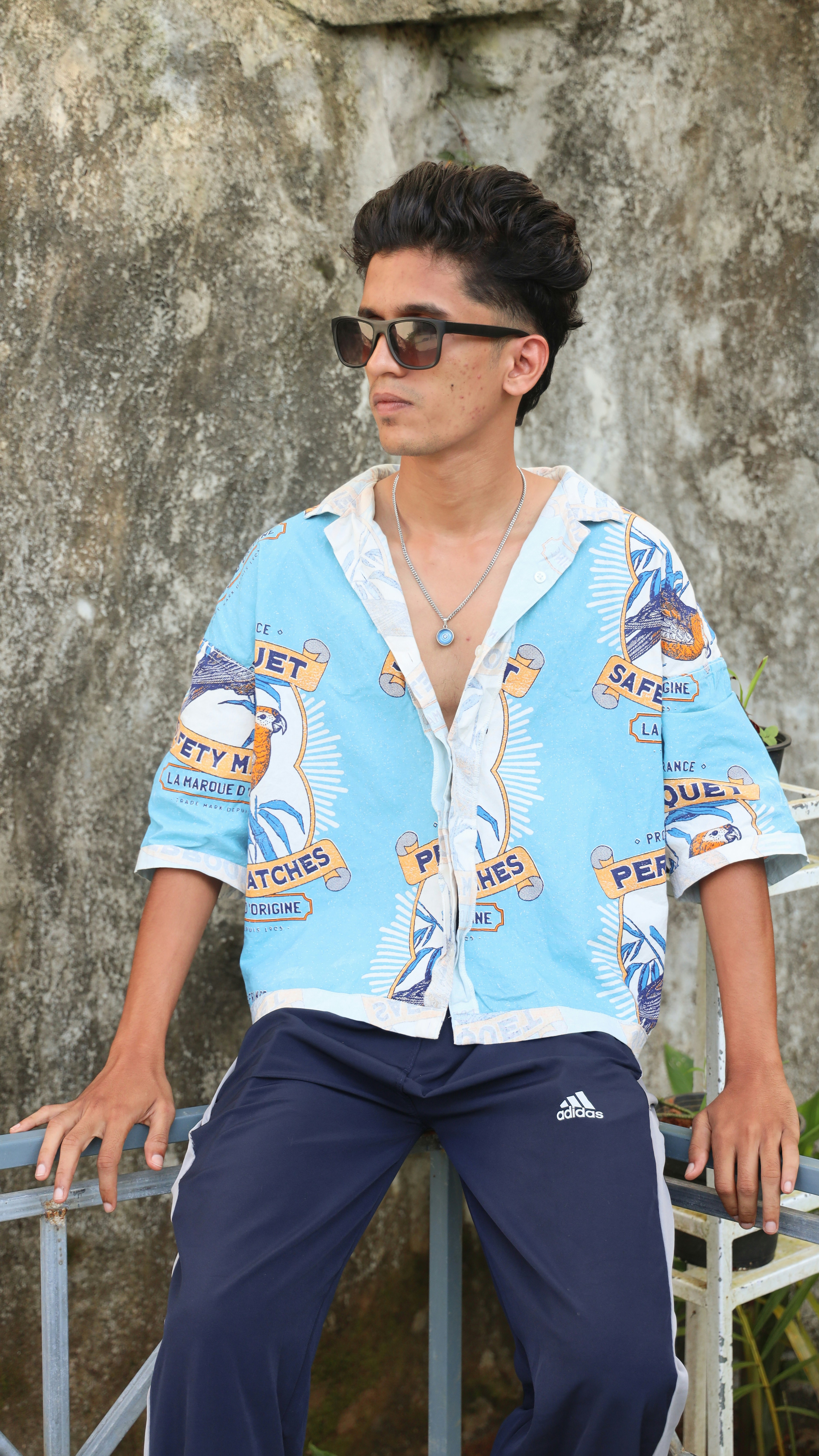 Young man in a patterned shirt and sunglasses