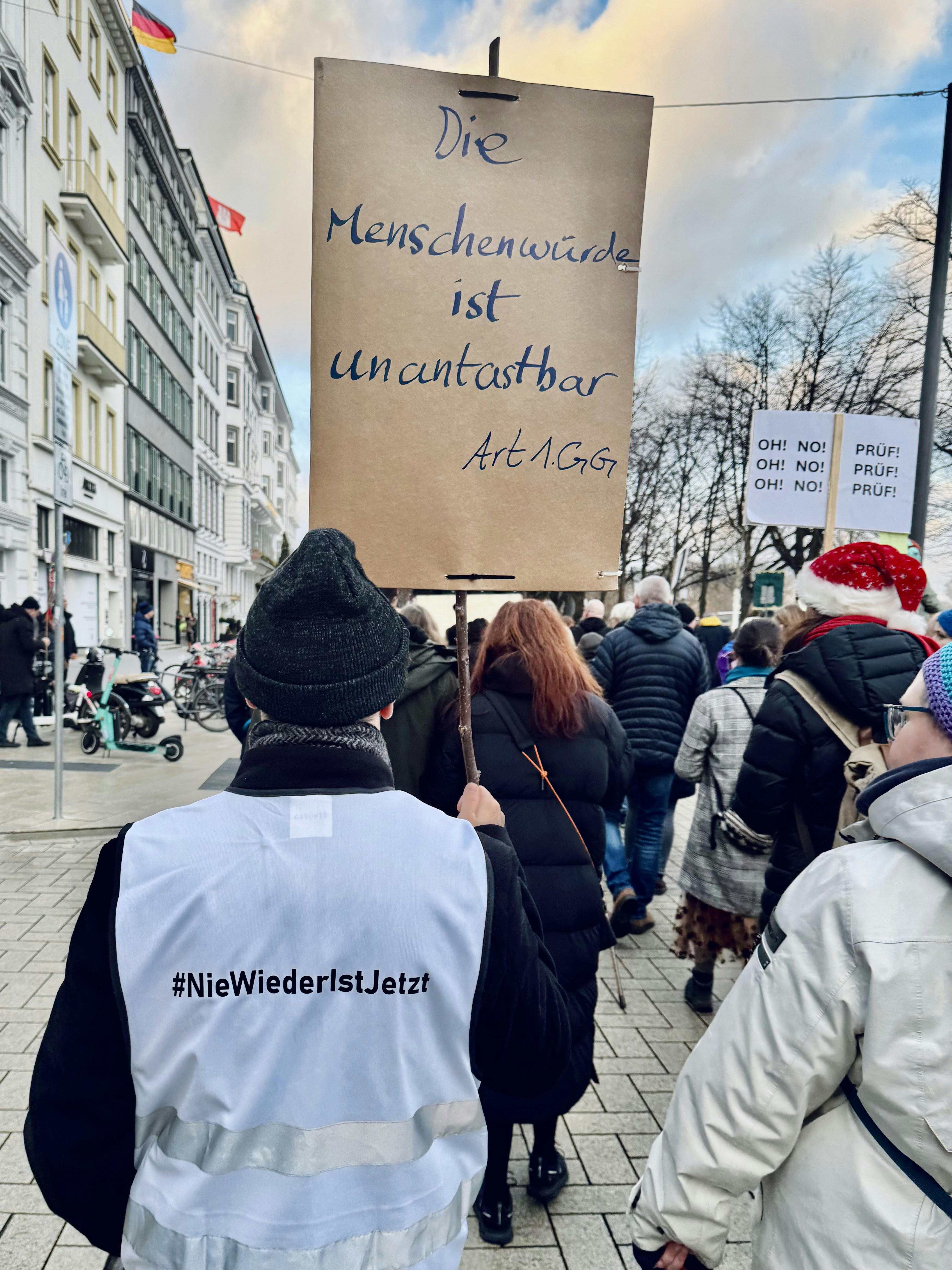 Protesters hold sign reading 
