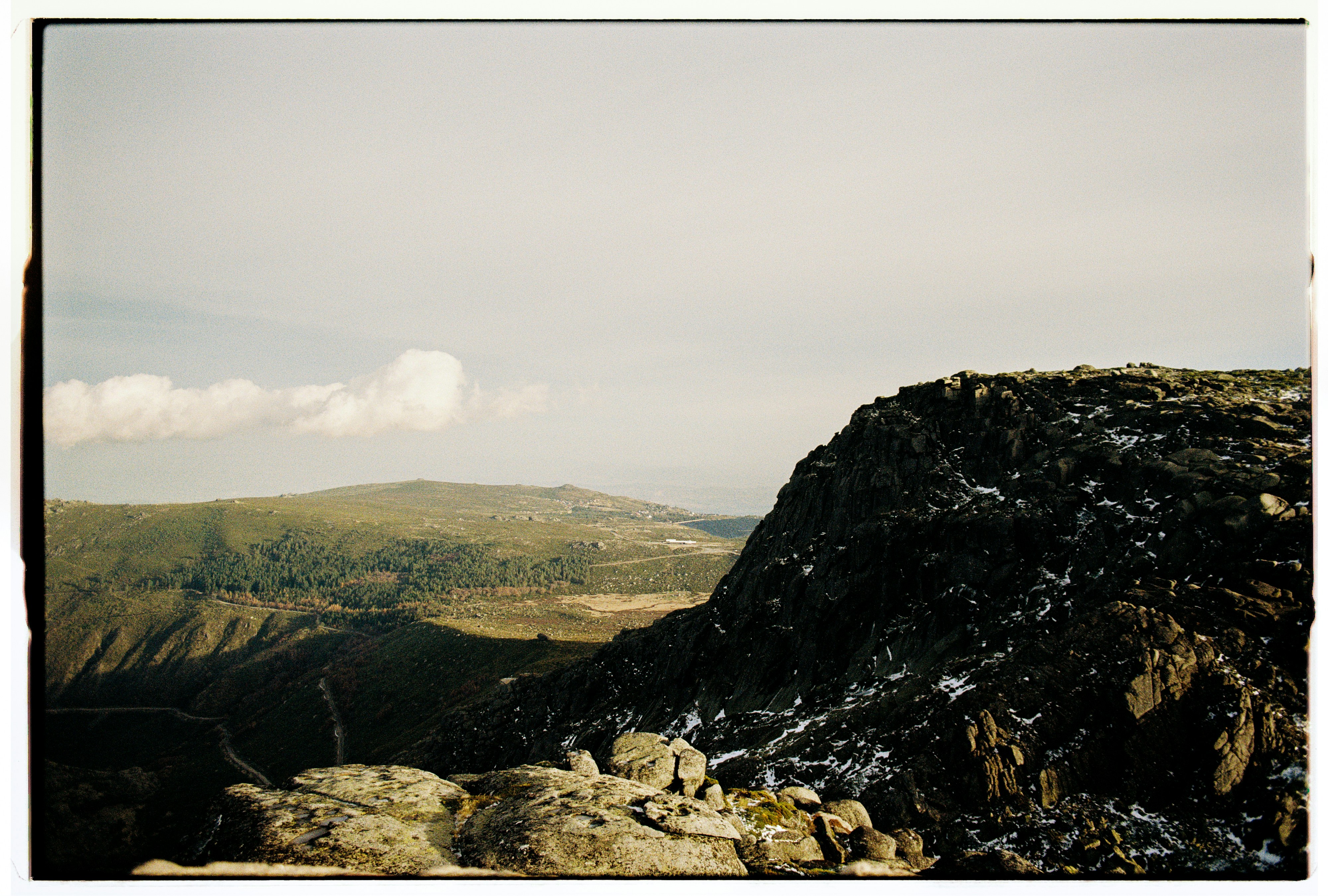 Rocky mountain landscape with green valleys below.