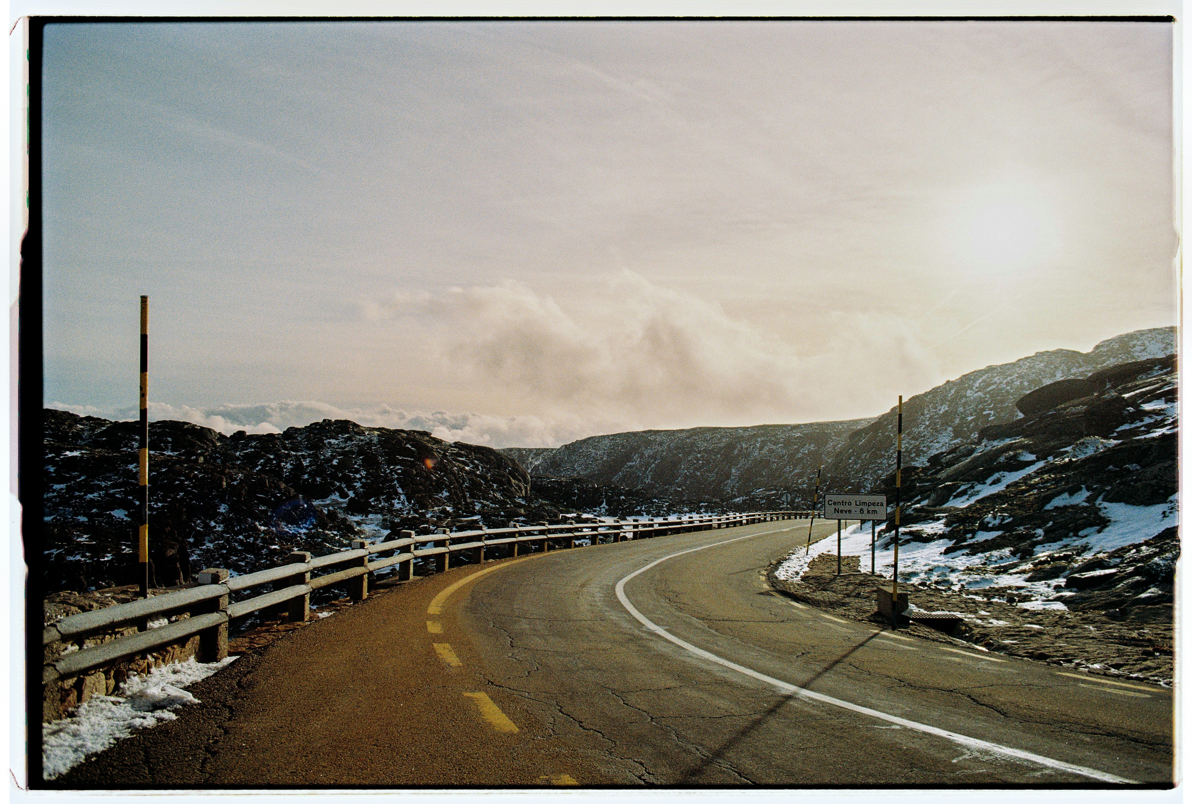 Curving mountain road with snow and sun photo – Free Travel Image on ...