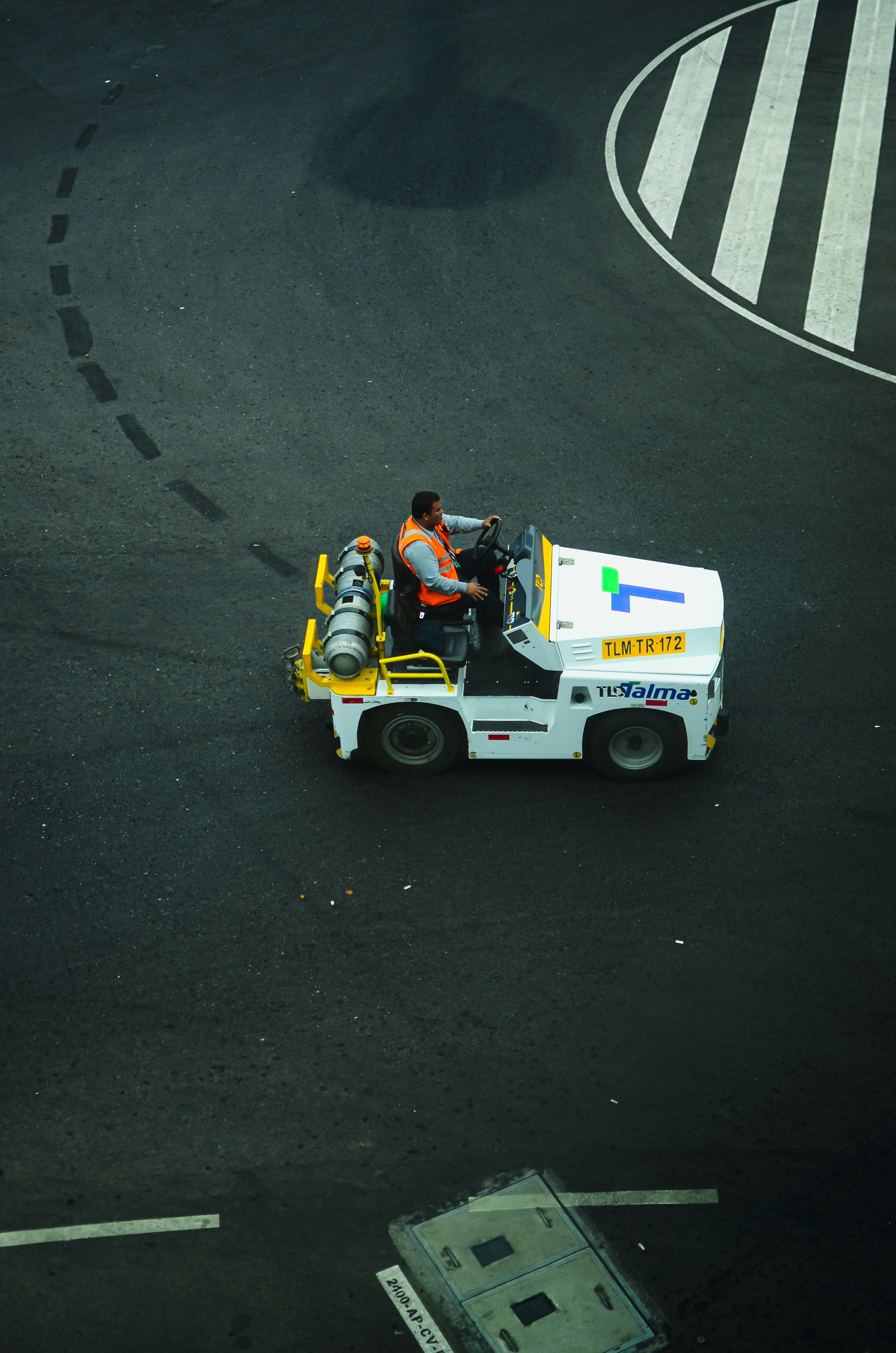 Man driving a tow tractor on an airport tarmac