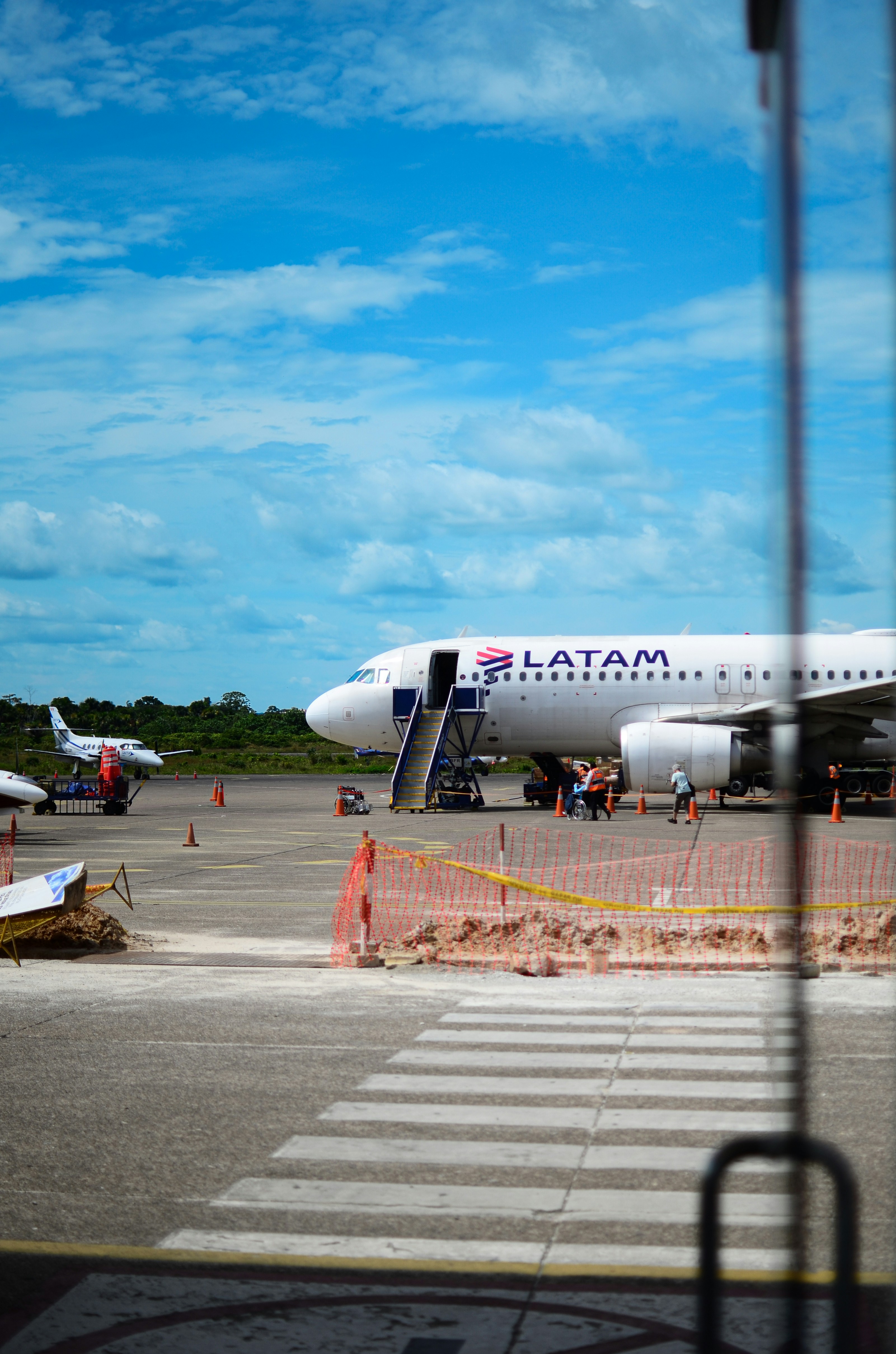 A latam airplane at an airport tarmac.