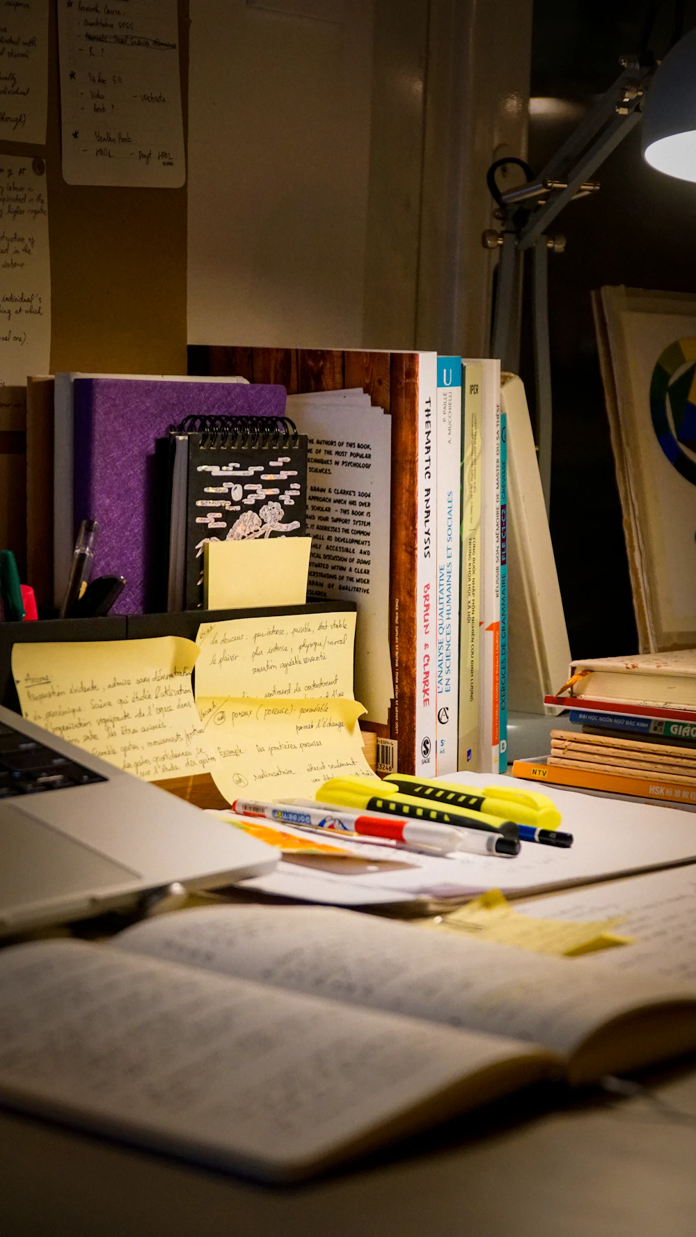 Open study book and notes on a desk