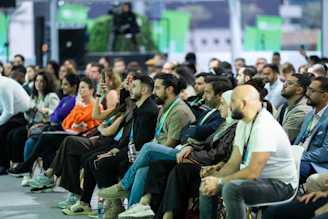 Diverse audience attentively listening at a conference event.