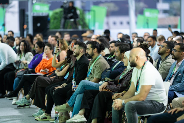 Diverse audience attentively listening at a conference event.
