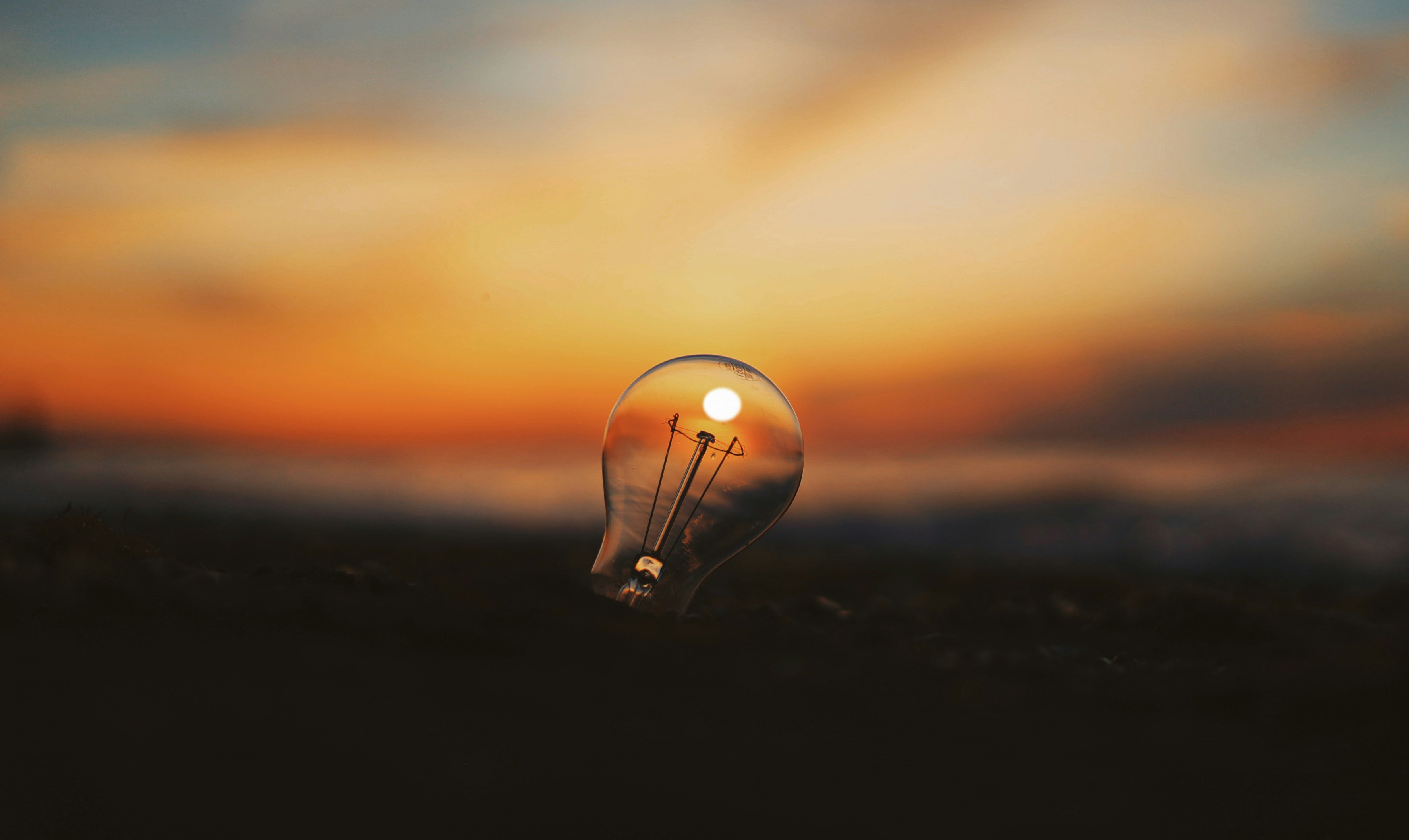 Lightbulb with sunset reflecting inside it
