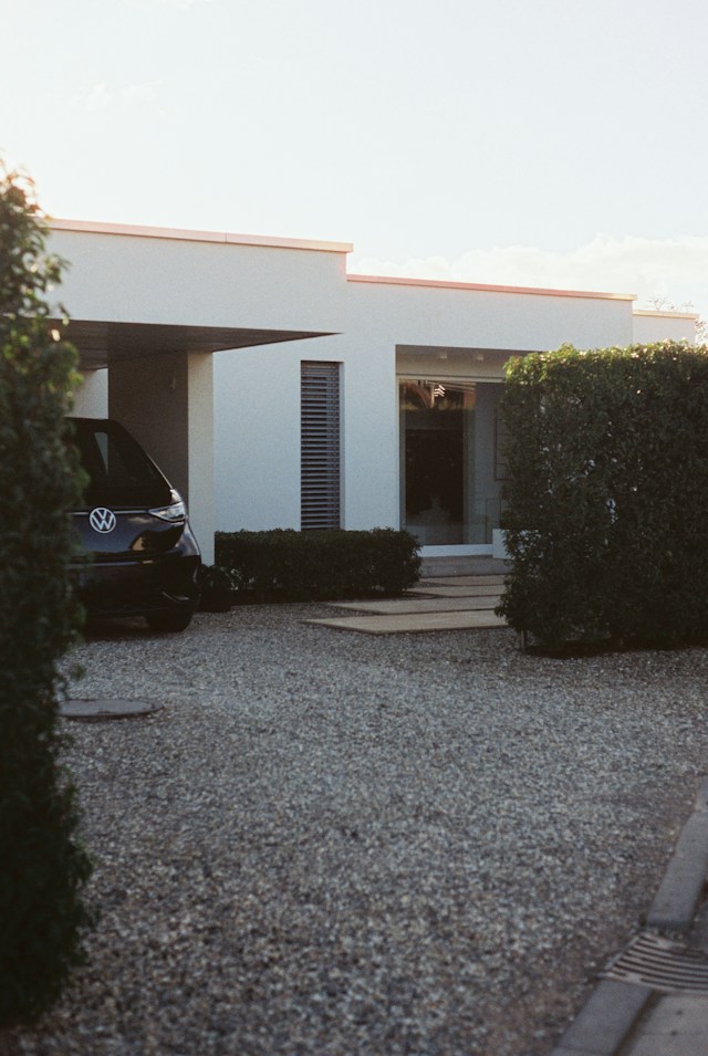 Modern white house with a gravel drive