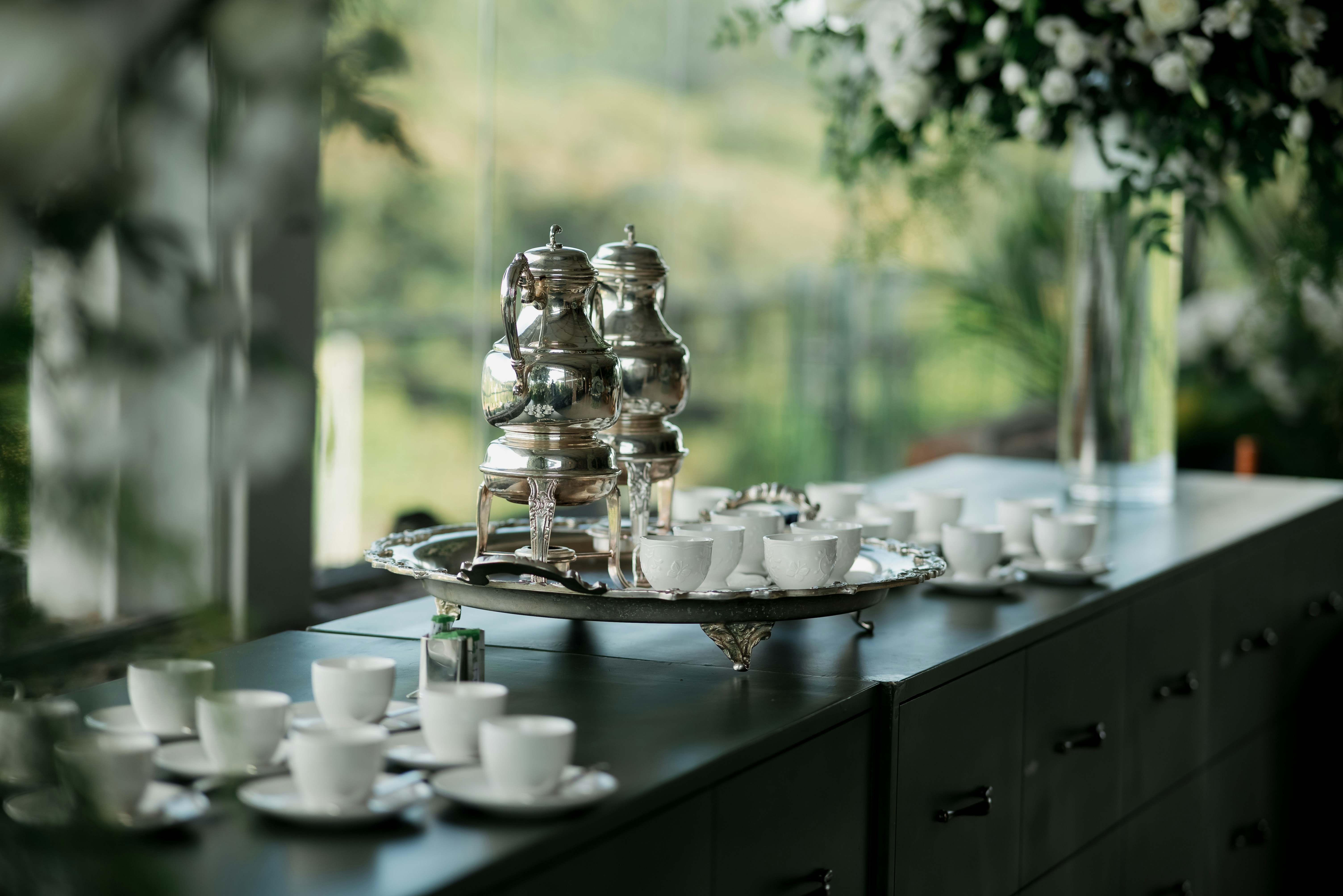 Silver coffee set with cups and saucers on table