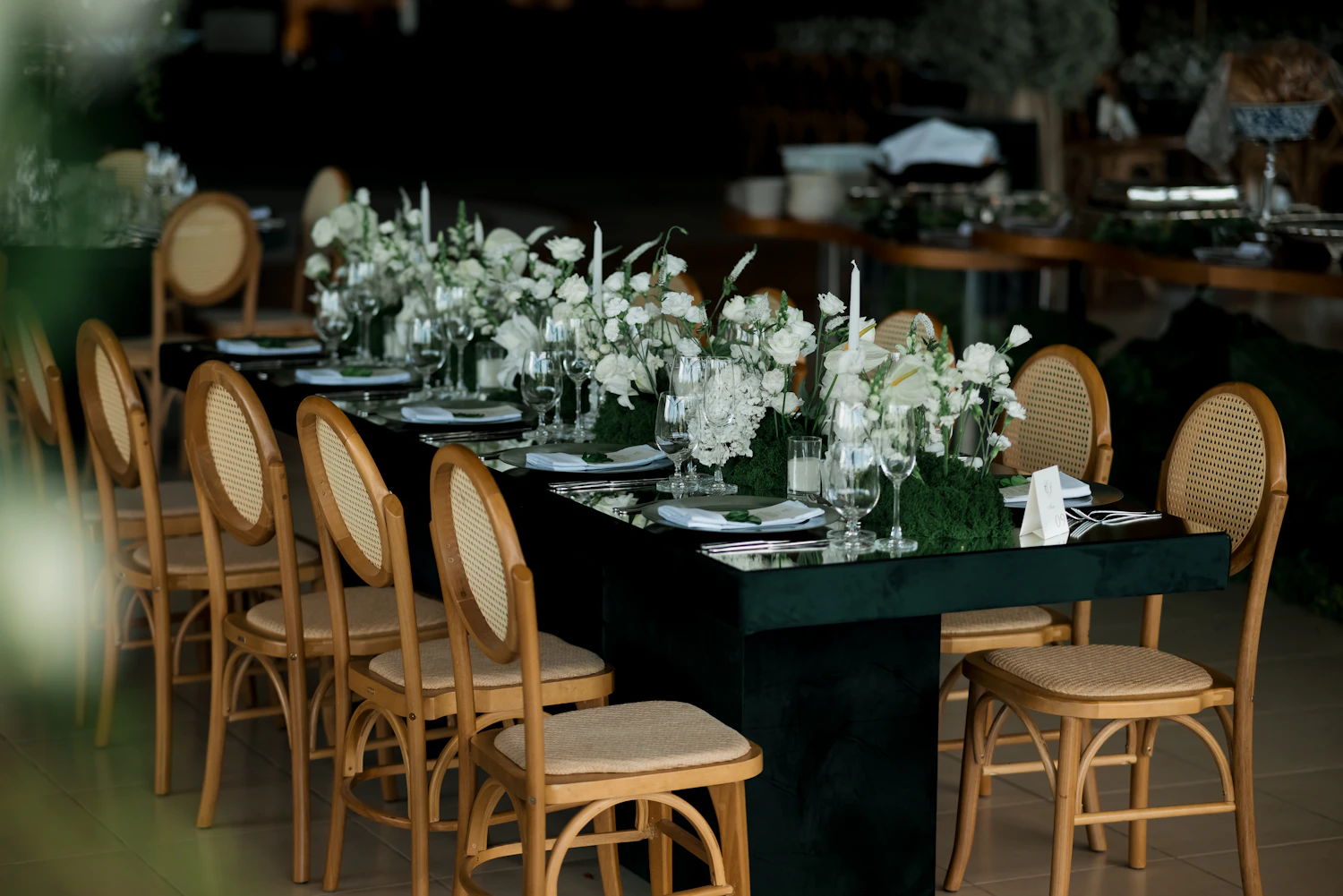 A long table set with white flowers for a private occasion