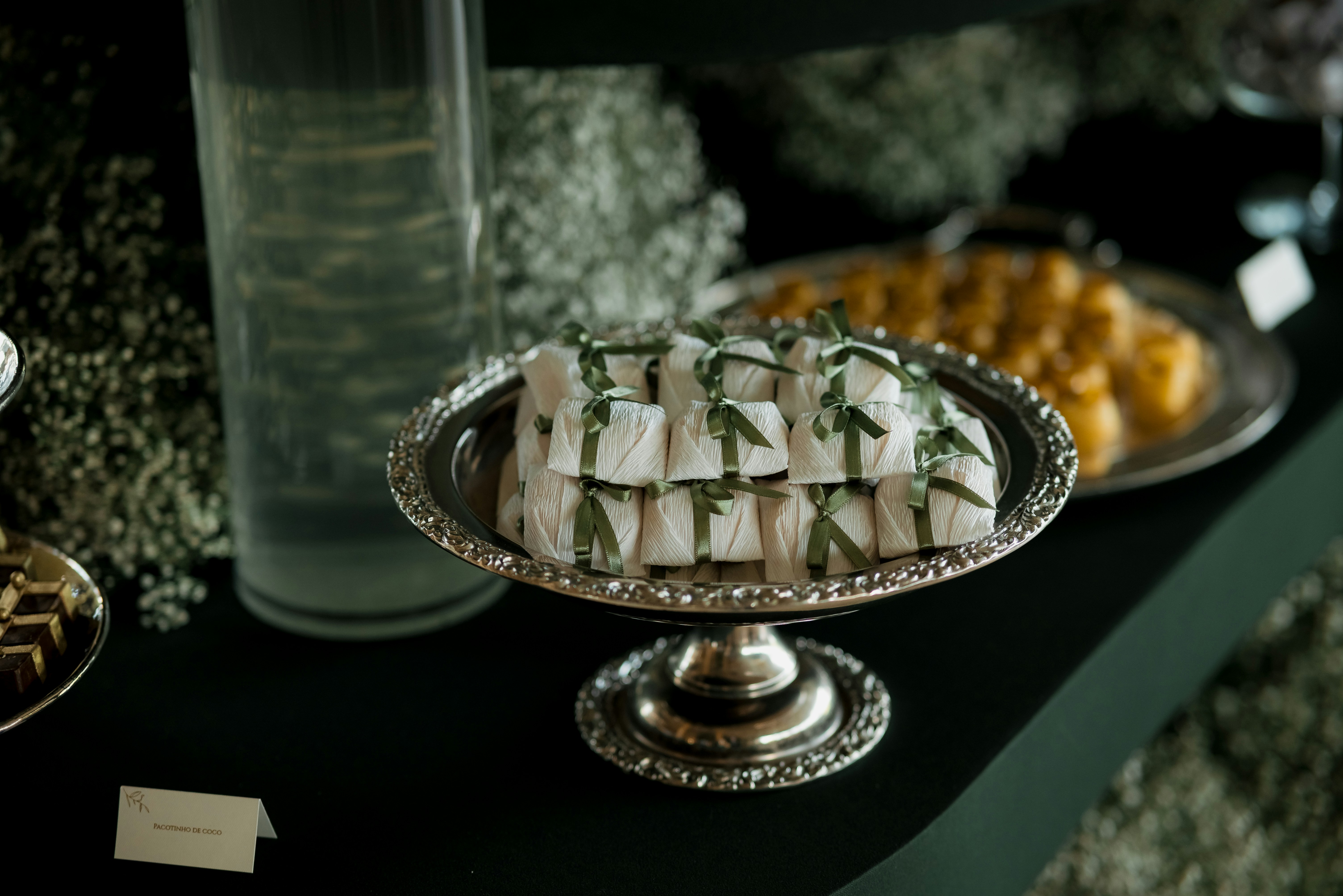 Dessert platter with white pastries and green garnish.