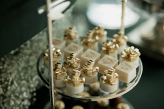Elegant gold-wrapped desserts arranged on a tiered stand