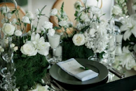 Elegant table setting with white flowers and dark plates