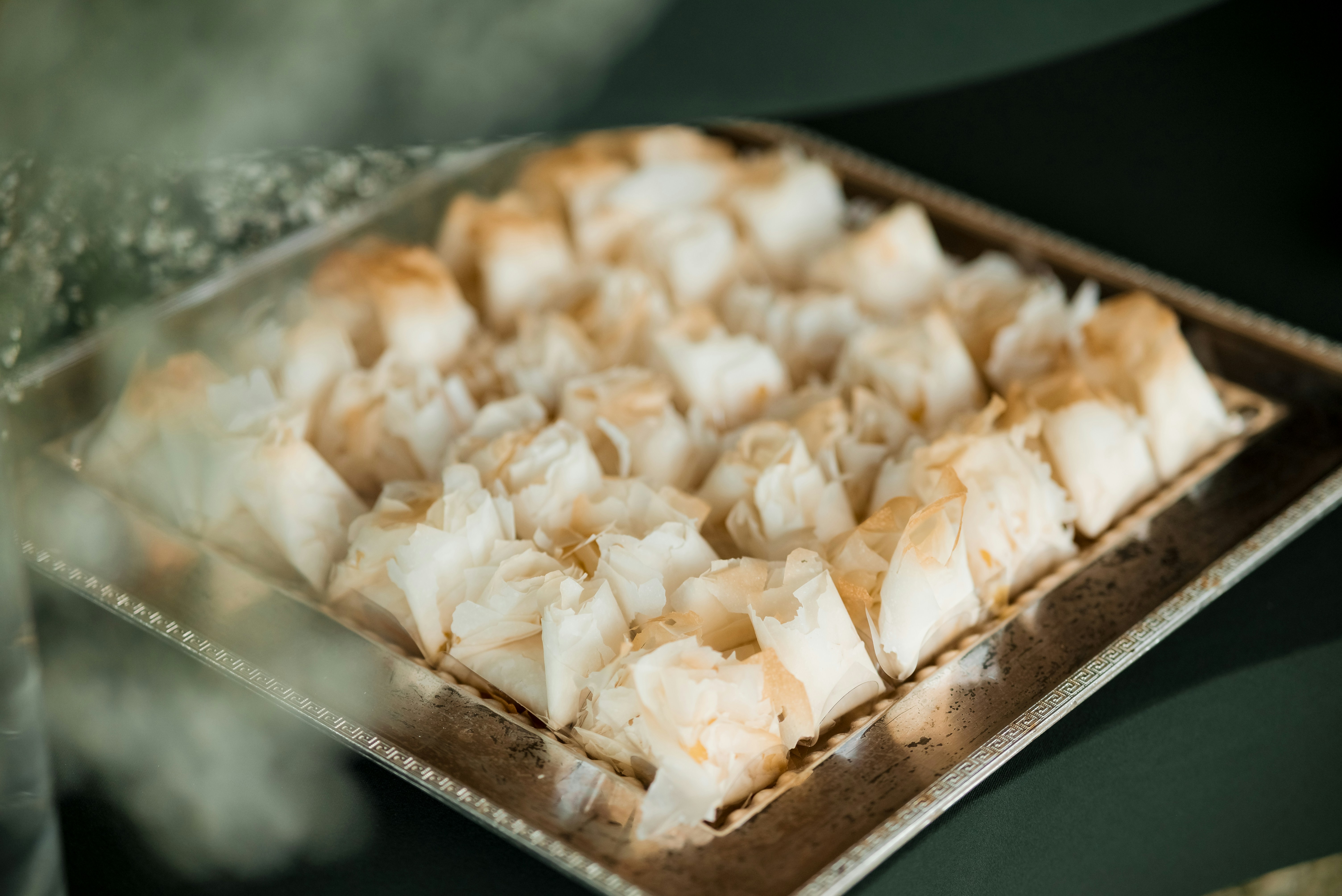 Golden pastries on silver tray