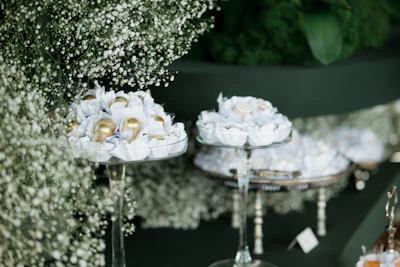 Elegant sweets displayed on tiered stands with floral decor.