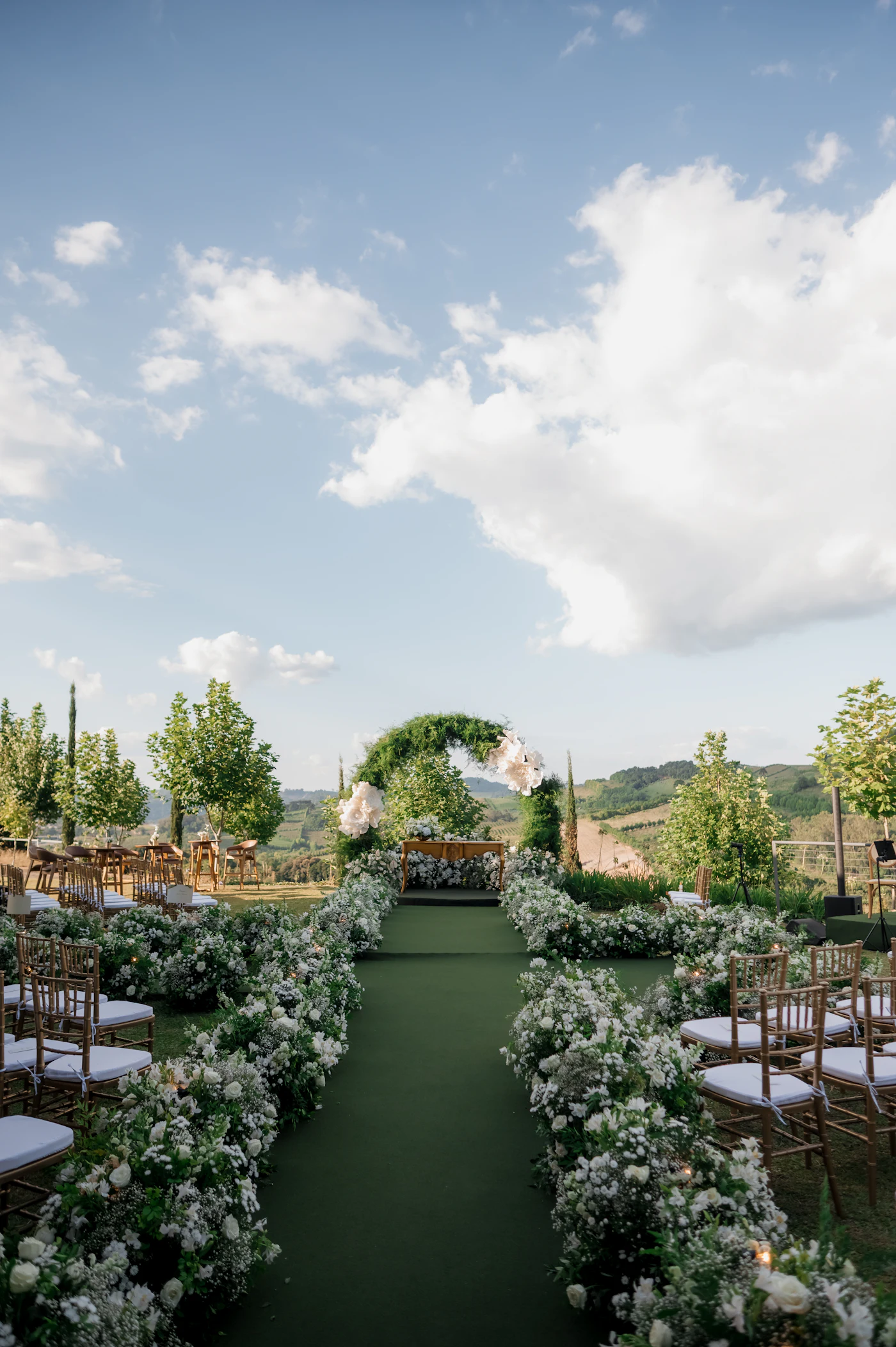 A floral arch and aisle set for a wedding on the estate lawn