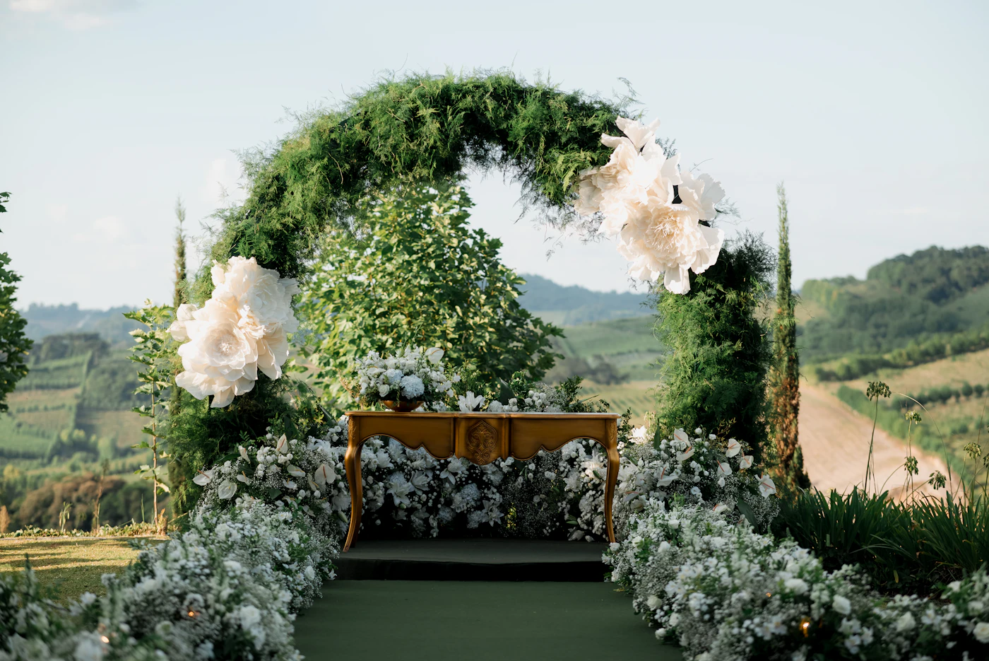 Wedding ceremony programs for interfaith unions — A couple exchanges vows under a decorated wedding arch.