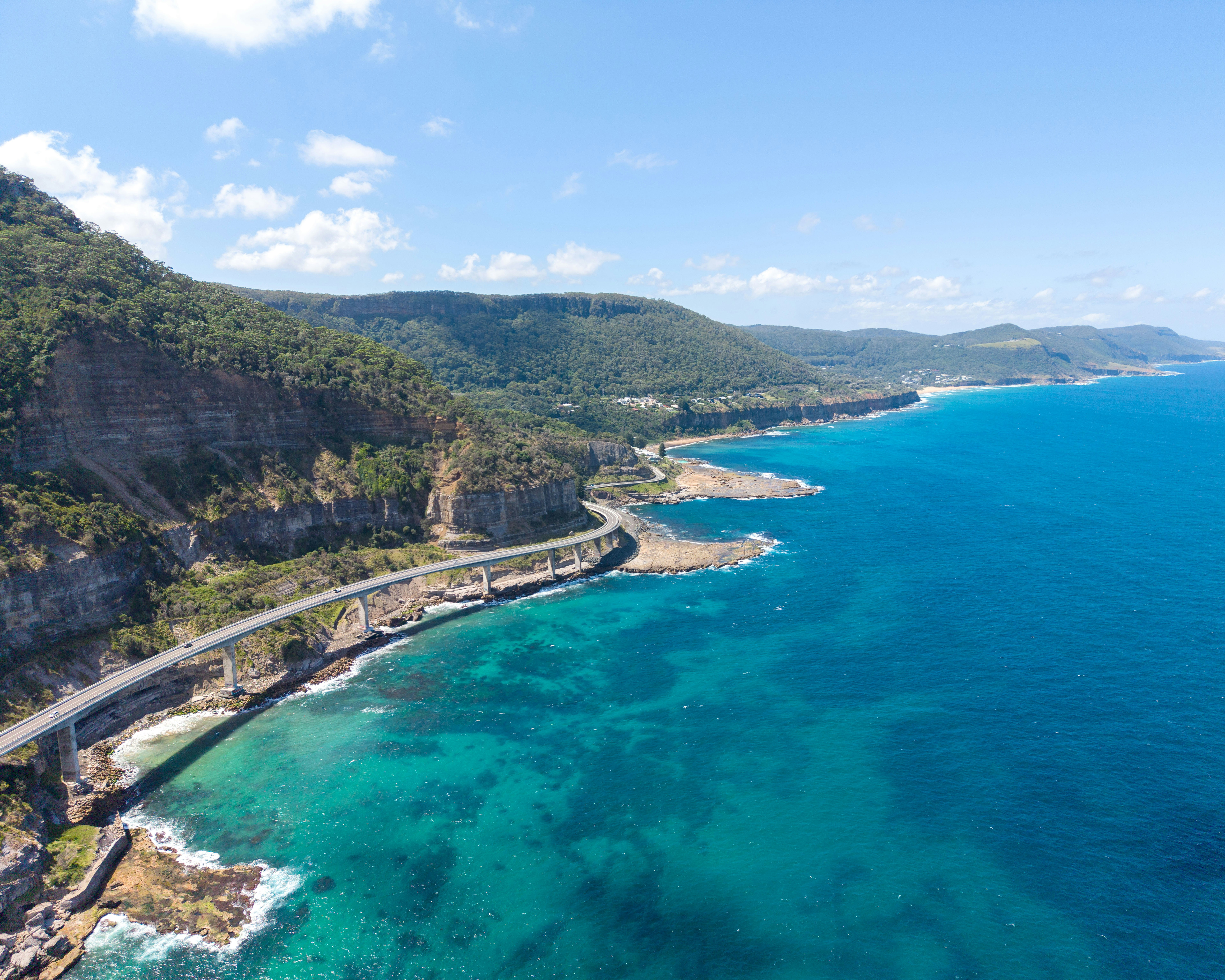 Coastal road winding along a rugged cliff by the ocean