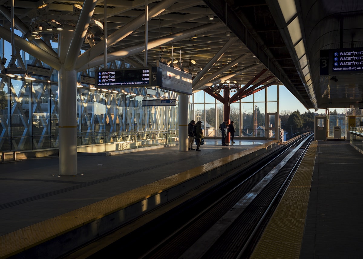 Modern train station platform with people waiting