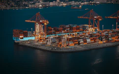 Container ship and cranes at a busy shipping port