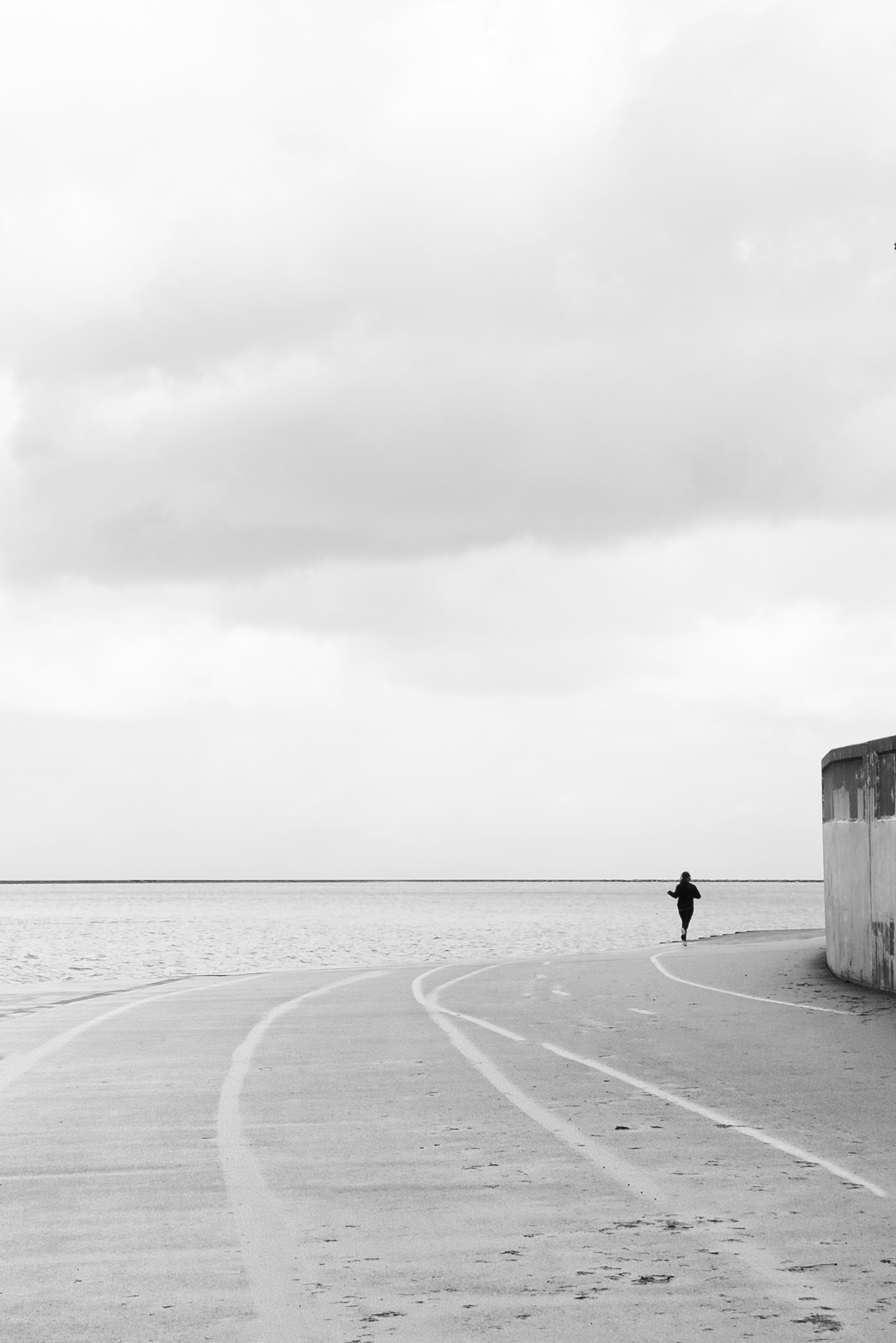 Lone person running on a coastal path