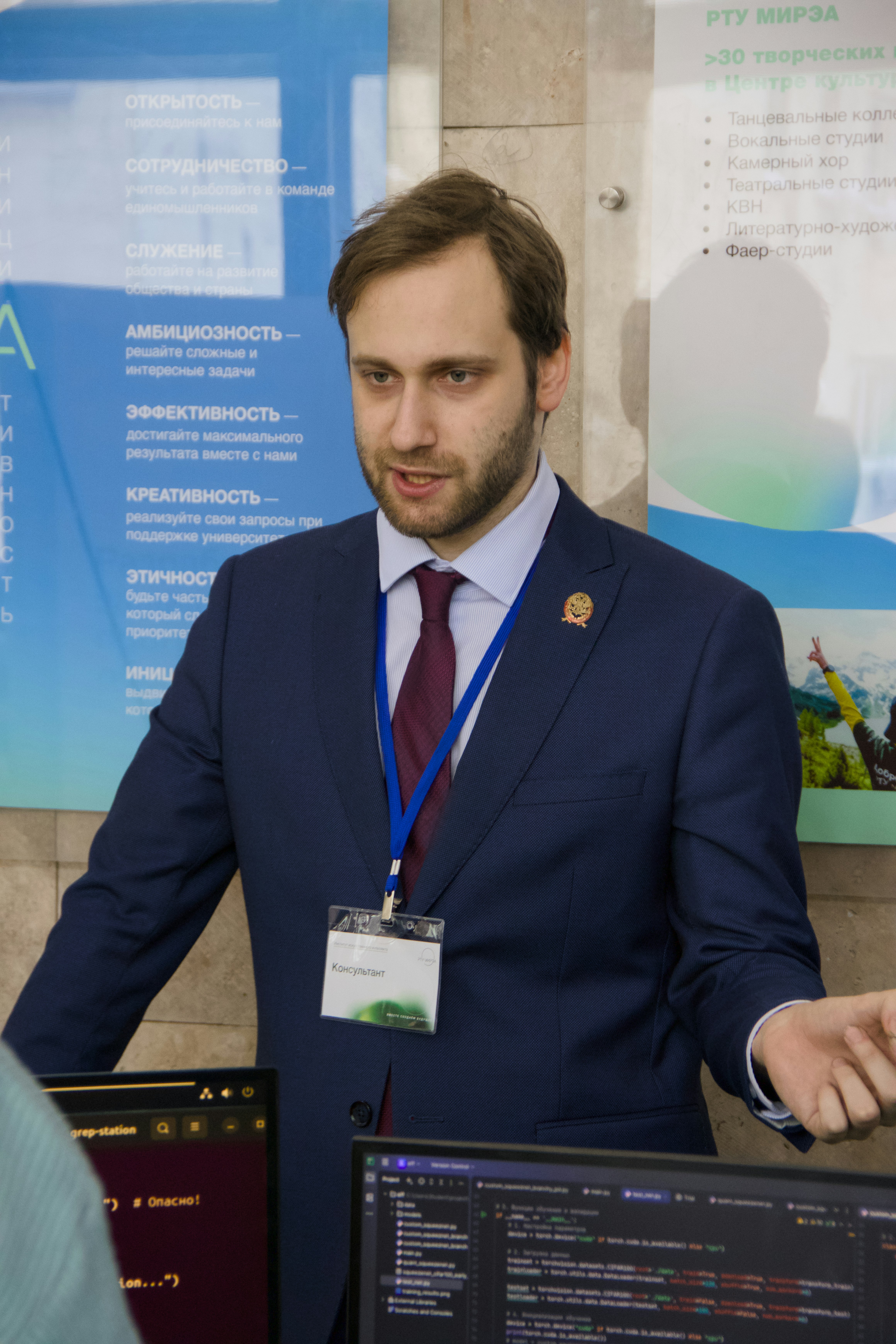 Man in suit speaking at a presentation