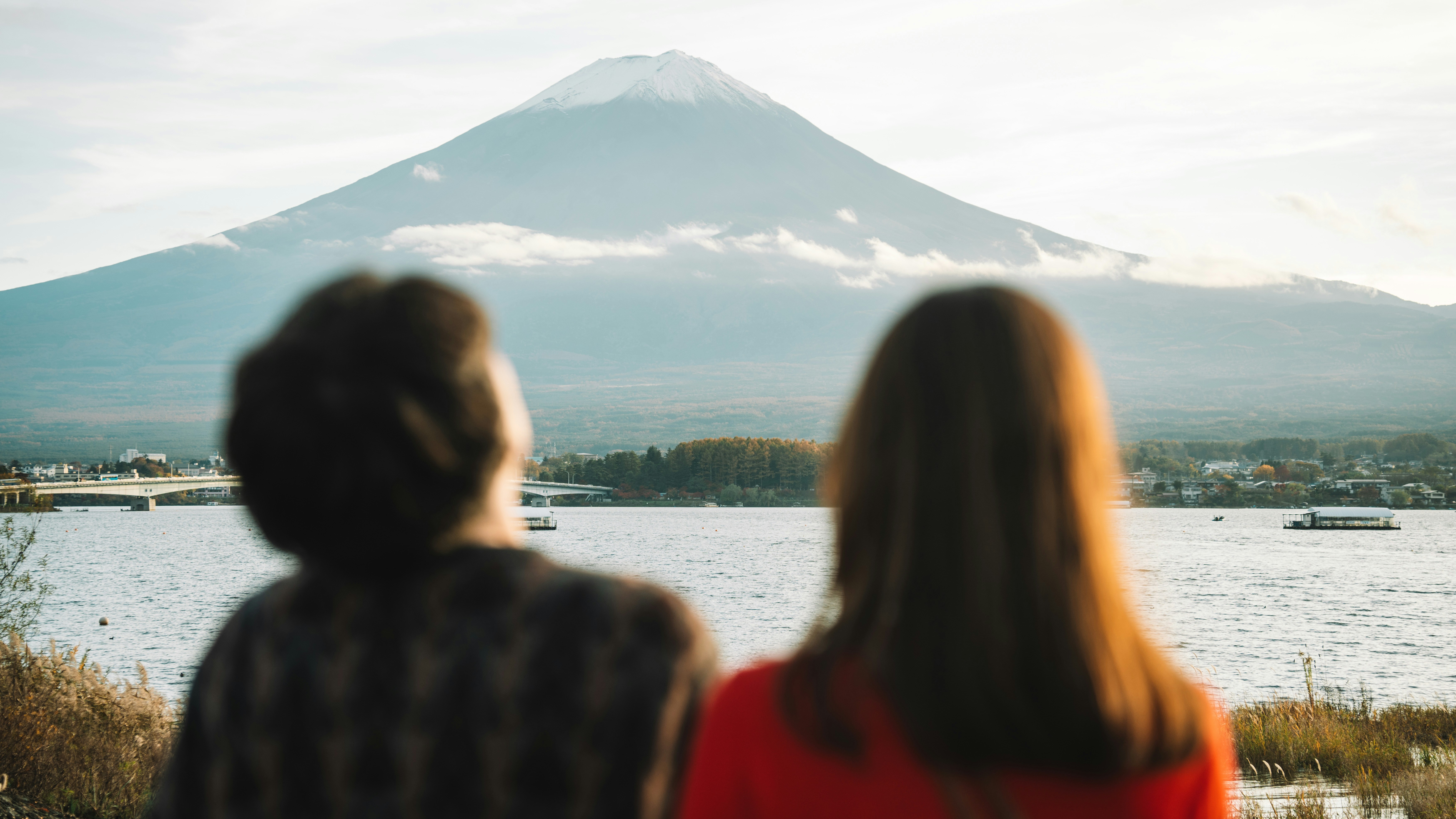 Couple admires mount fuji across a lake