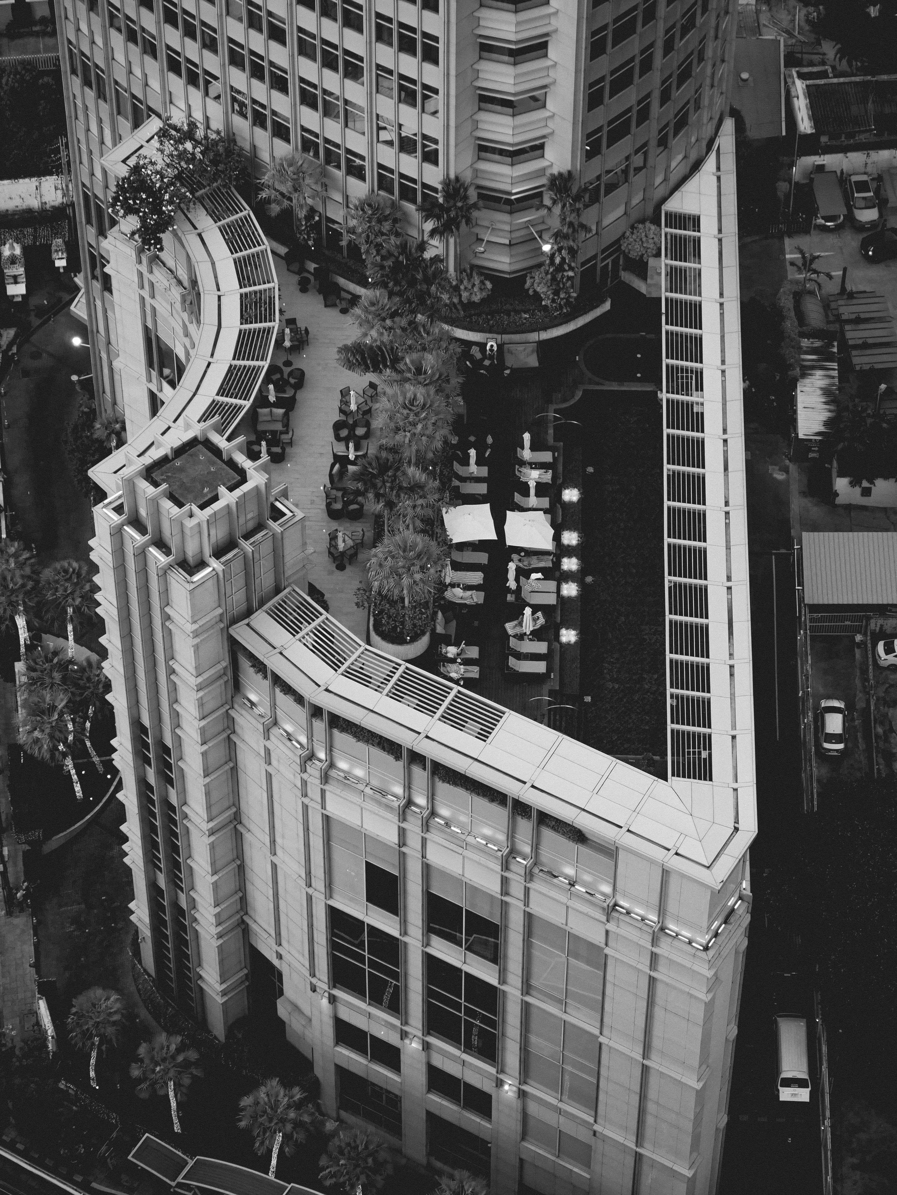 Aerial view of a modern building with rooftop seating area.