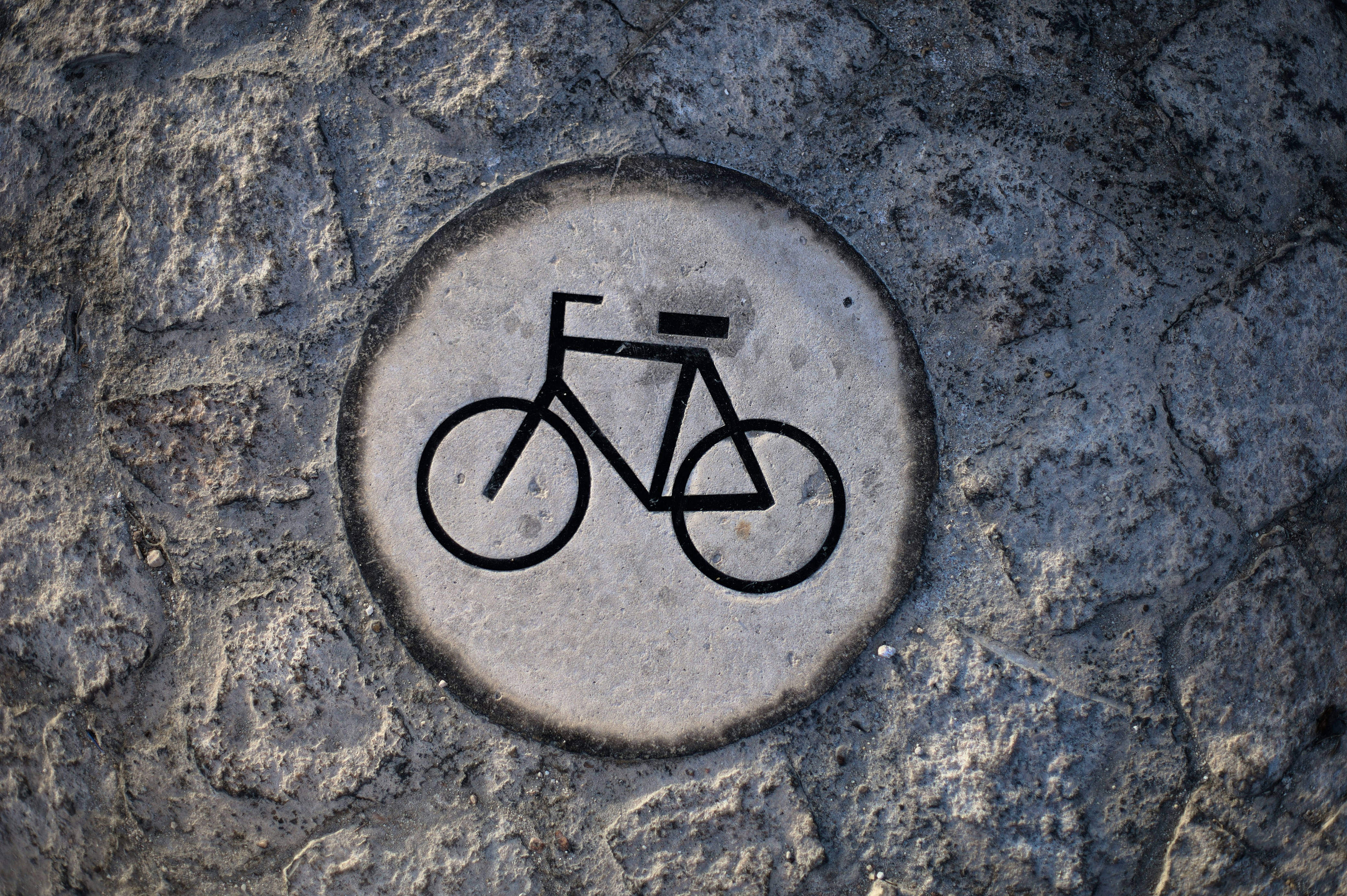Bicycle symbol embedded in stone pathway