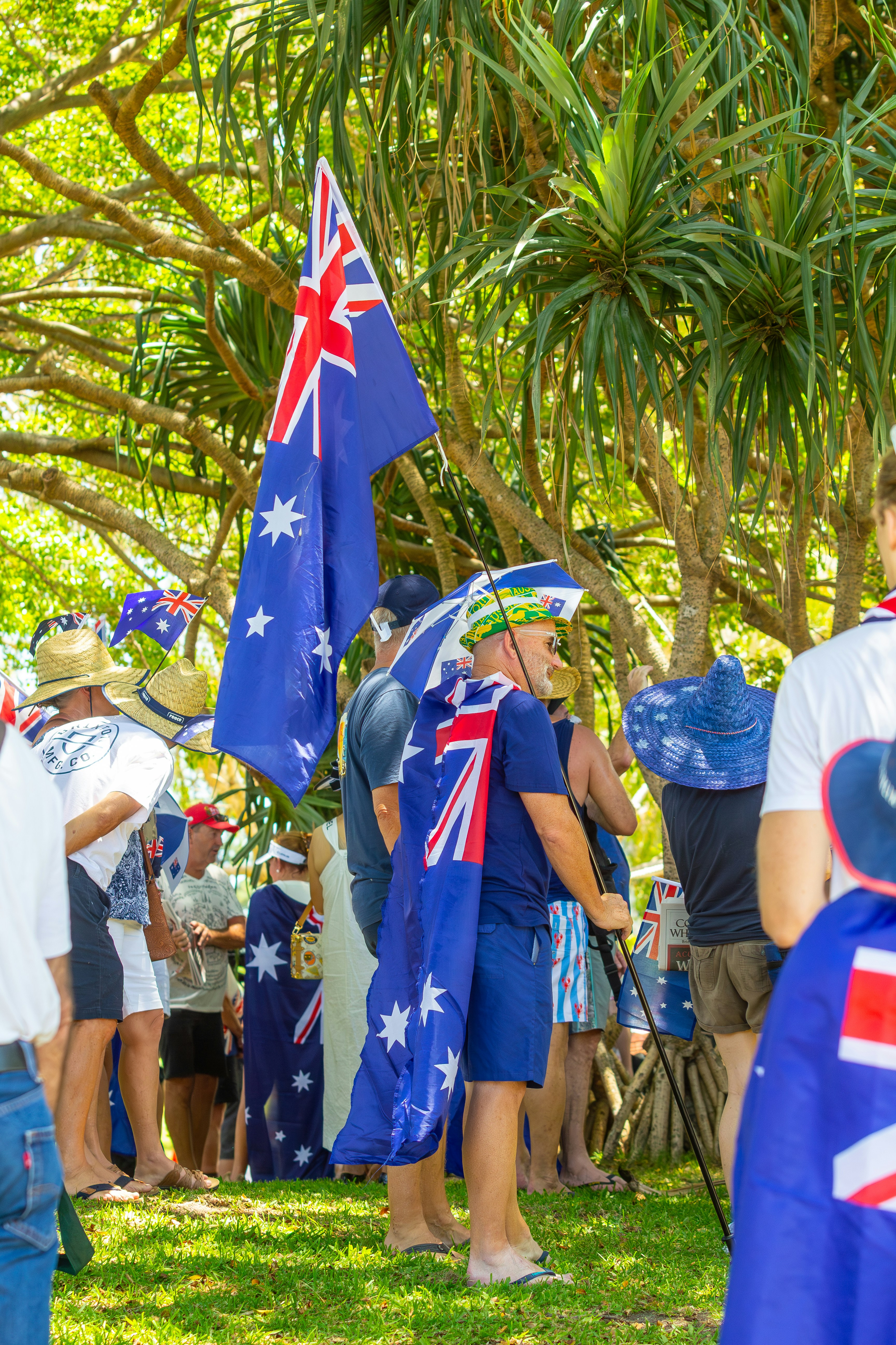 People wearing australian flags and hats at an outdoor event