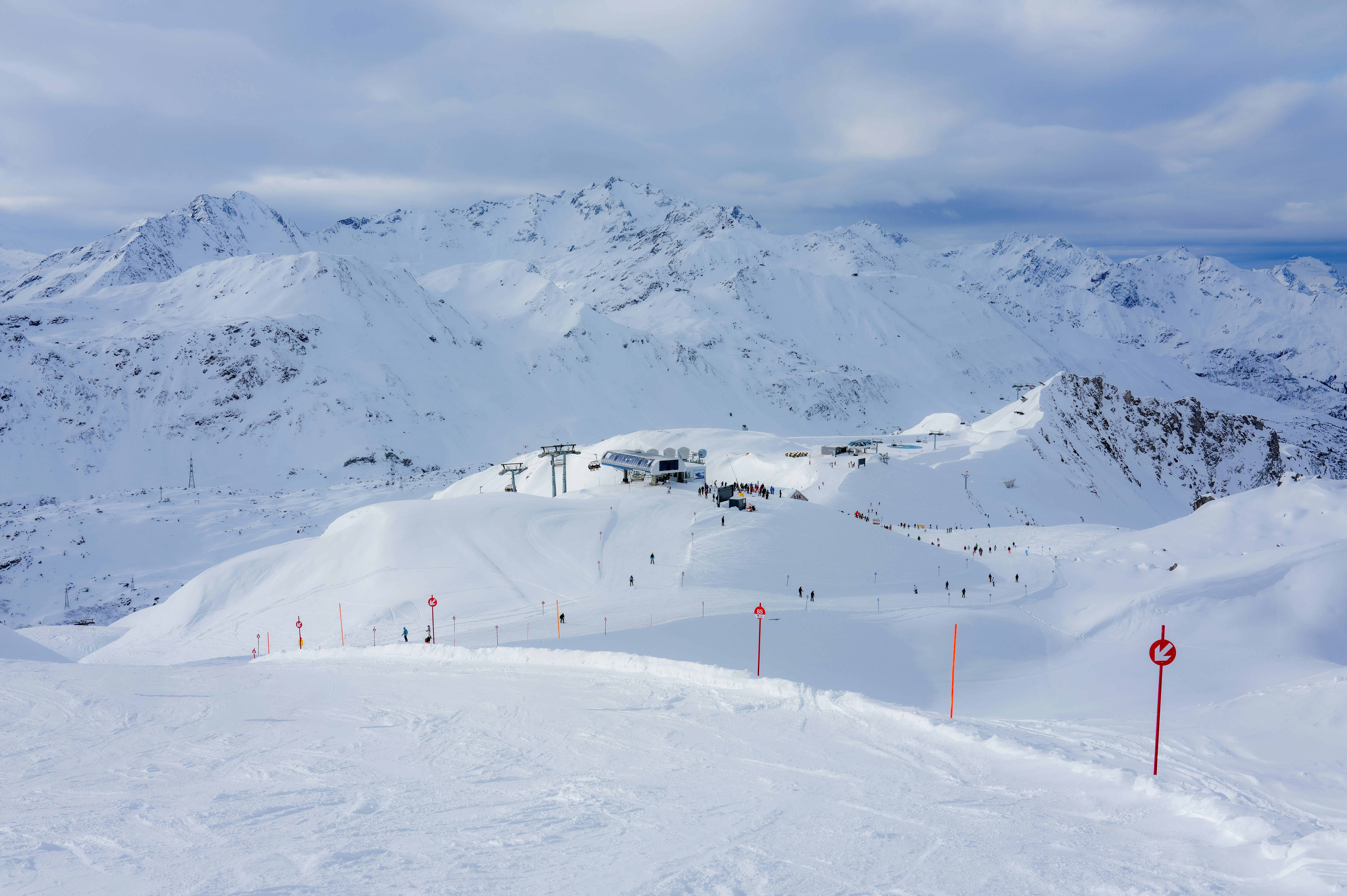 Snowy mountain landscape with ski slopes and ski lifts.