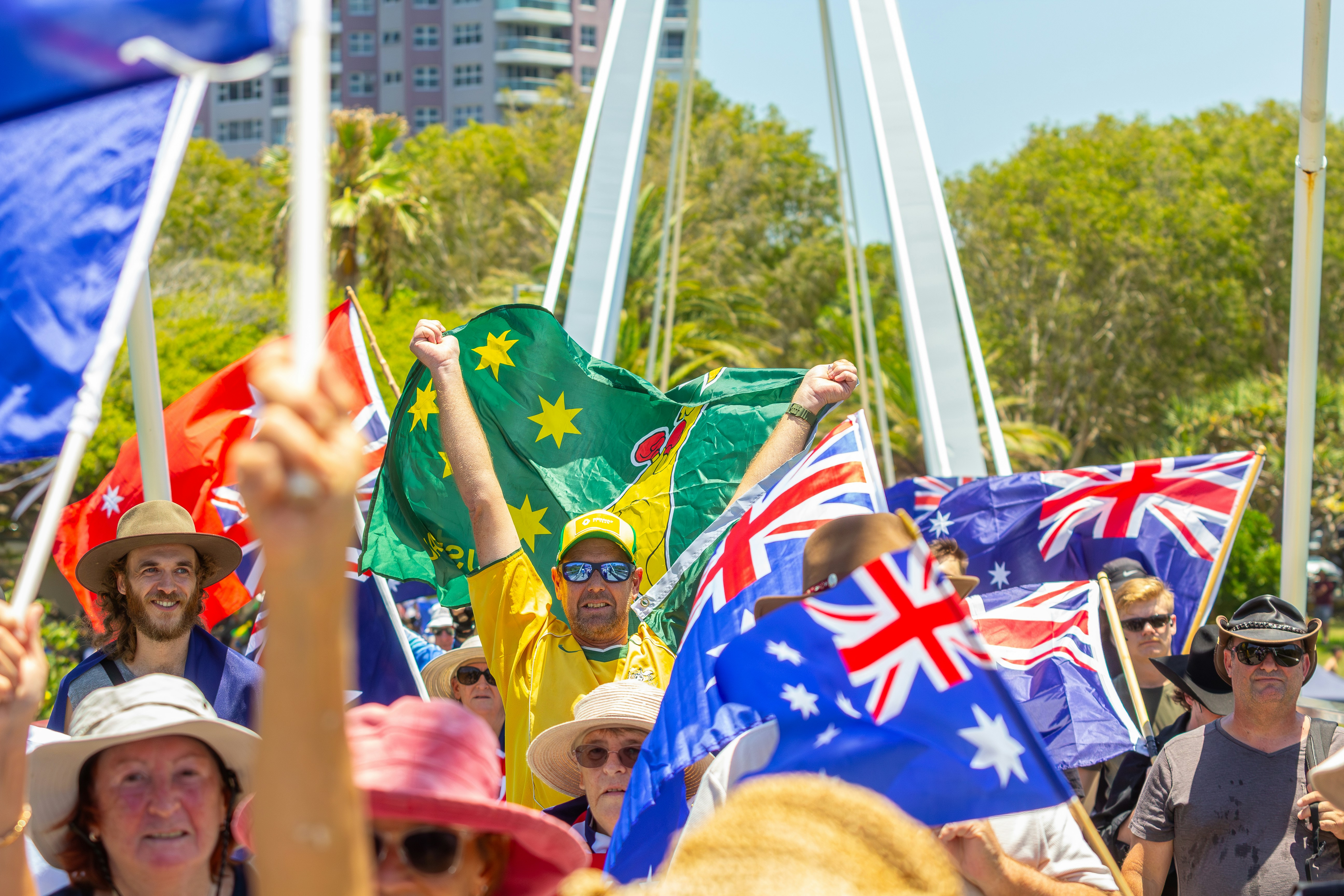 Crowd waving australian flags at an outdoor event