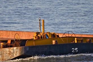 A yellow barge with the number 25 on its side