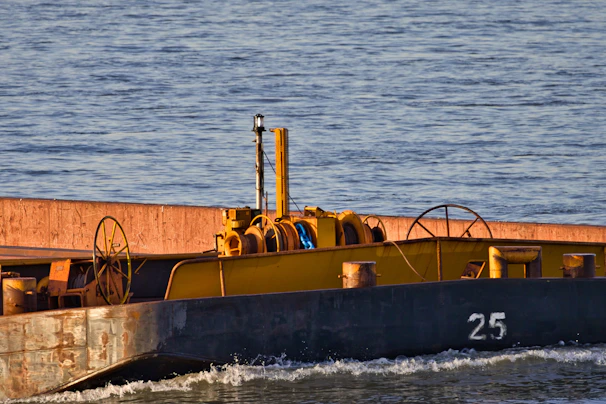 A yellow barge with the number 25 on its side