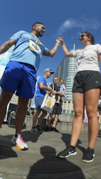 Two runners high-fiving after a race