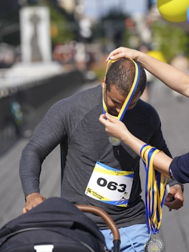 Man receives medal after race with baby stroller