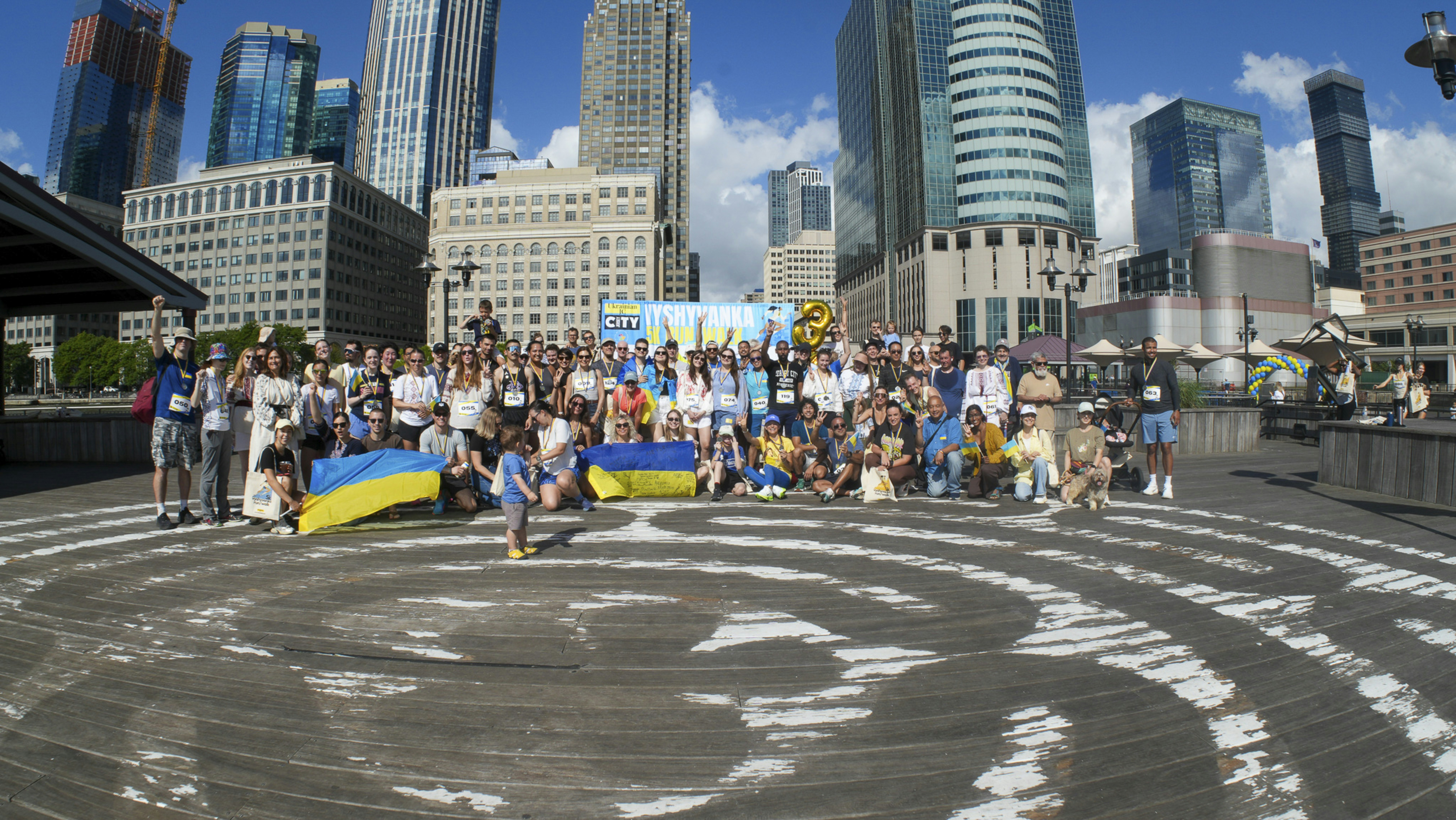 Large group of people with ukrainian flags in city