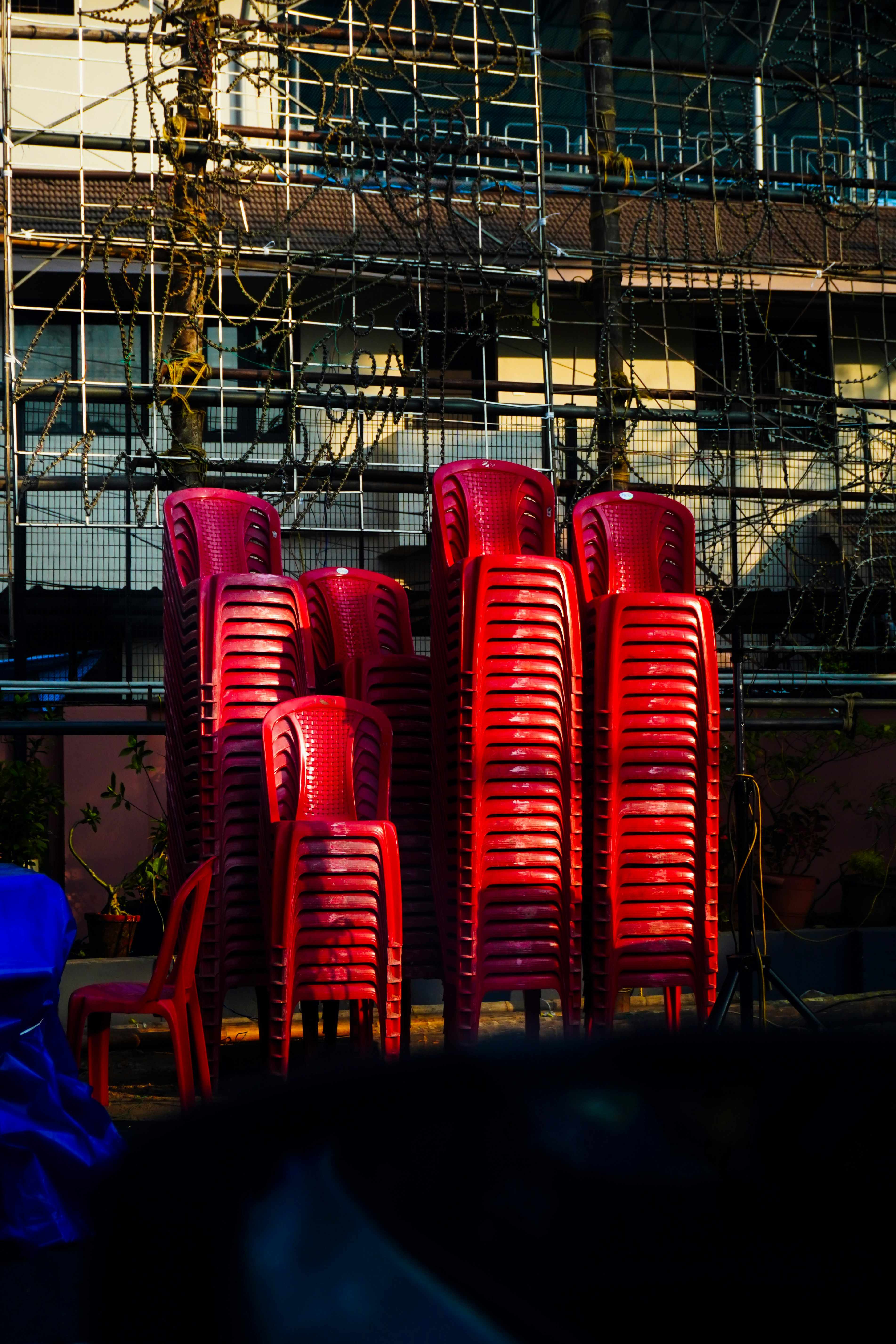Stacks of red plastic chairs outdoors