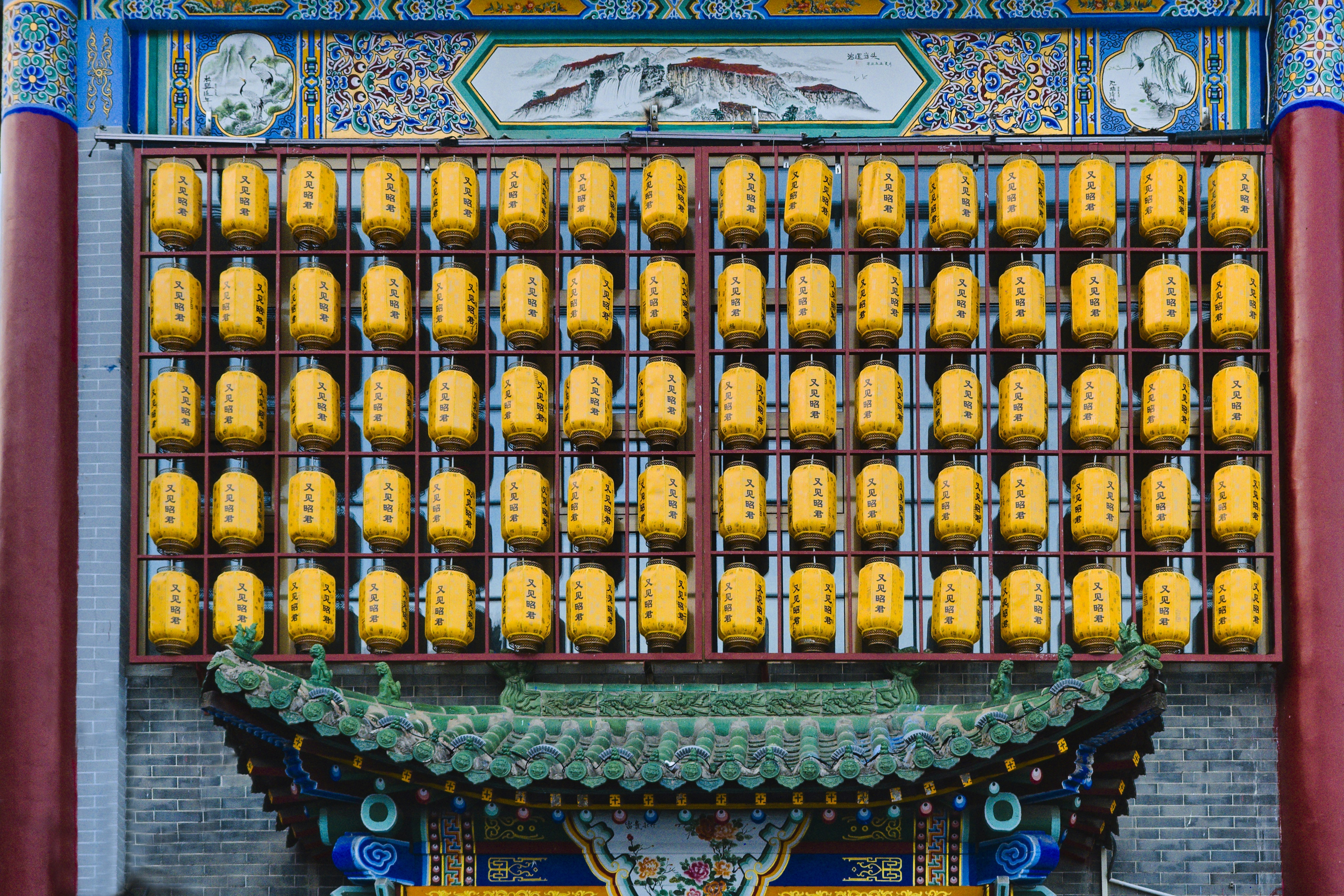 Rows of yellow lanterns displayed on a building