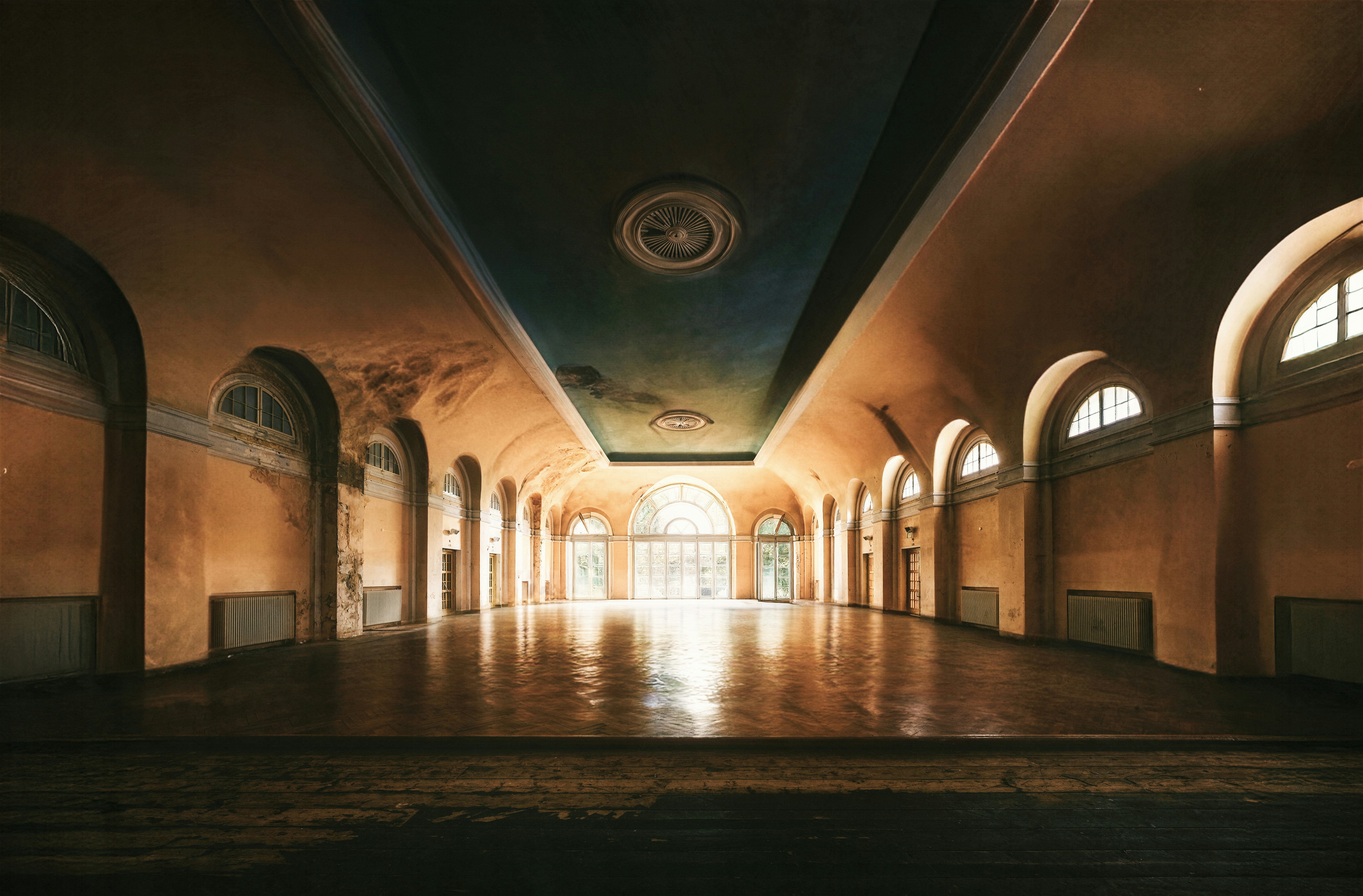 Grand hall with arched windows and ornate ceiling