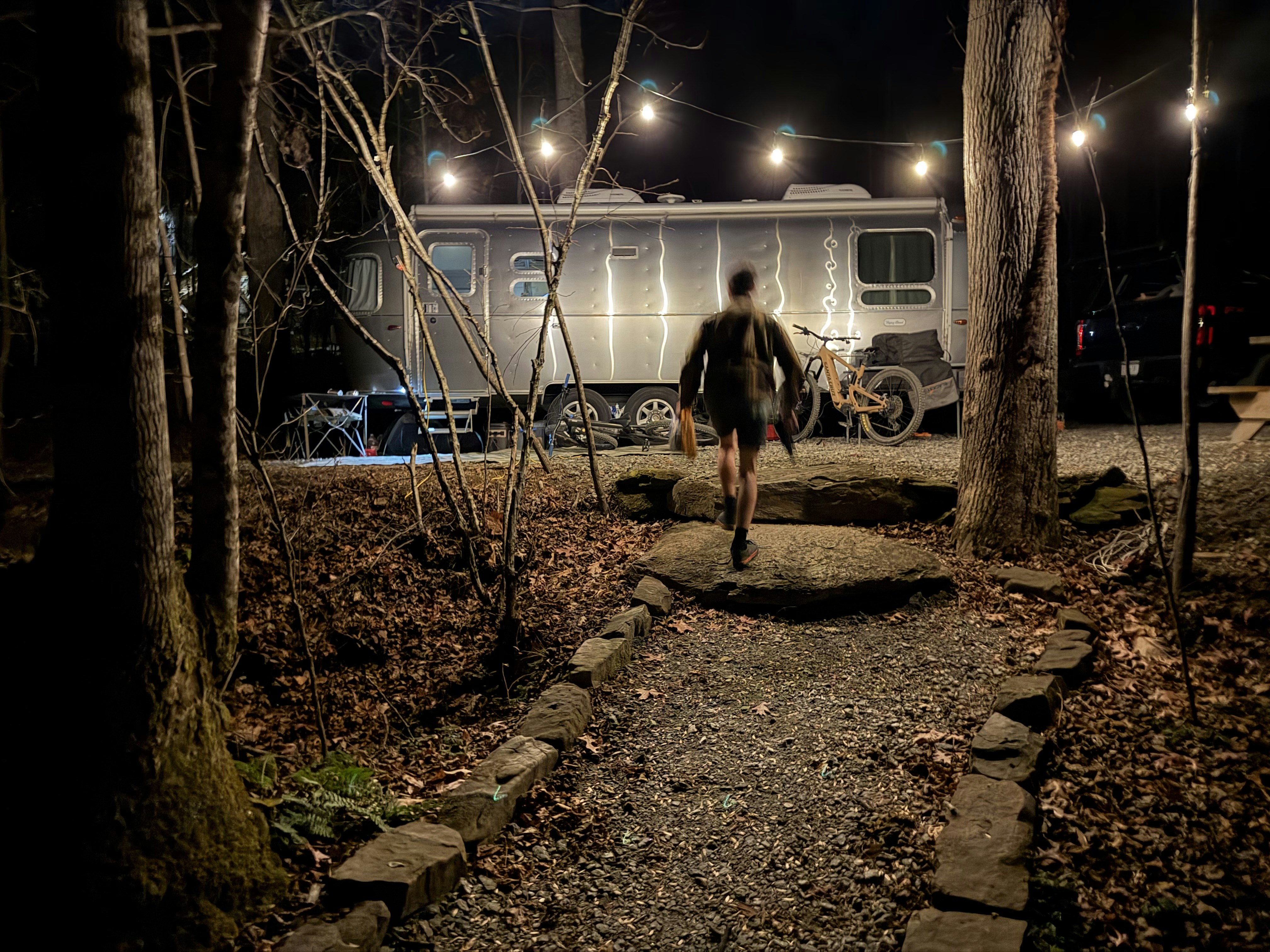 Person walking towards a trailer at night