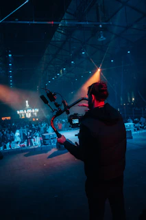 Filmmaker operating a gimbal with camera at event