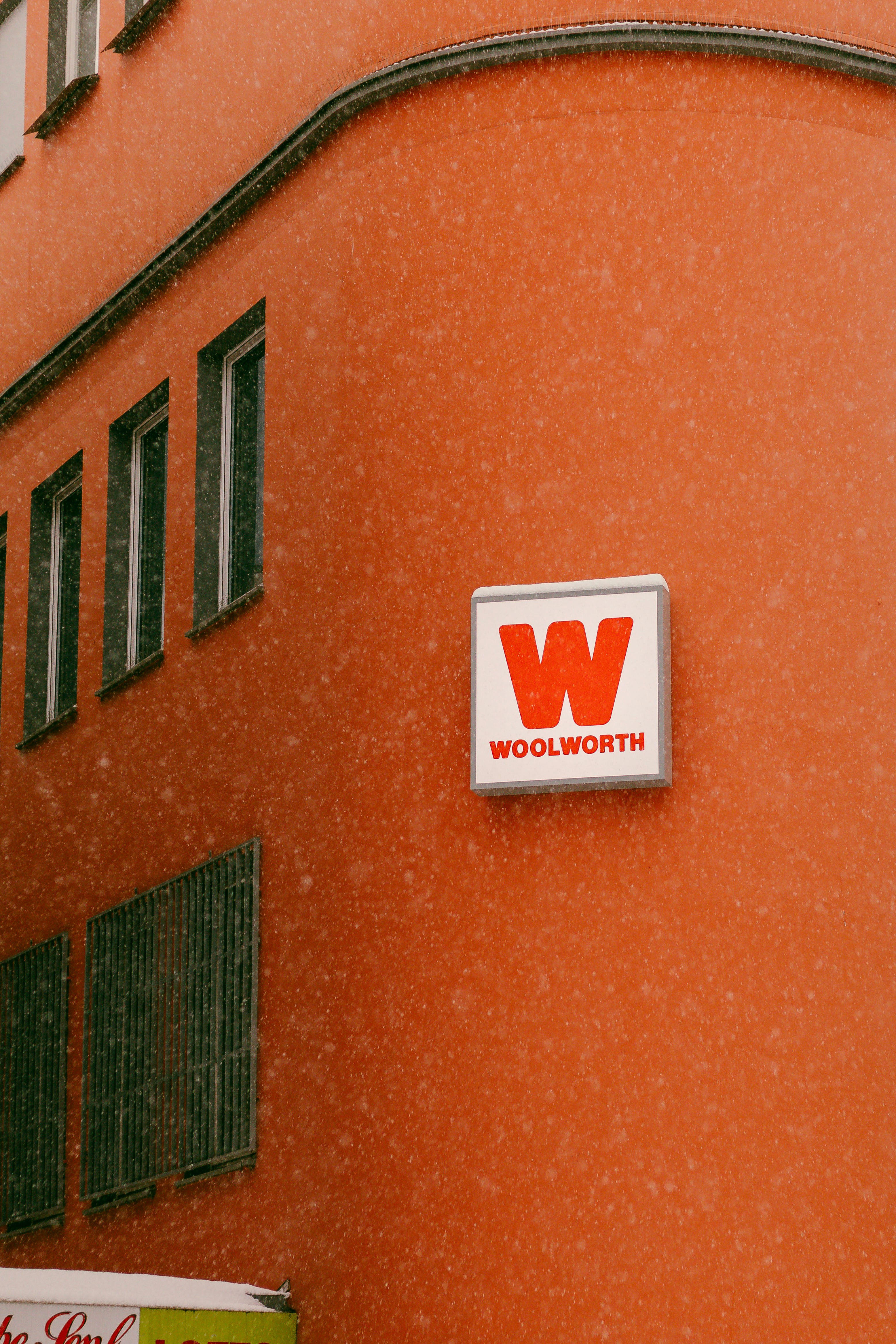 Woolworth sign on an orange building wall