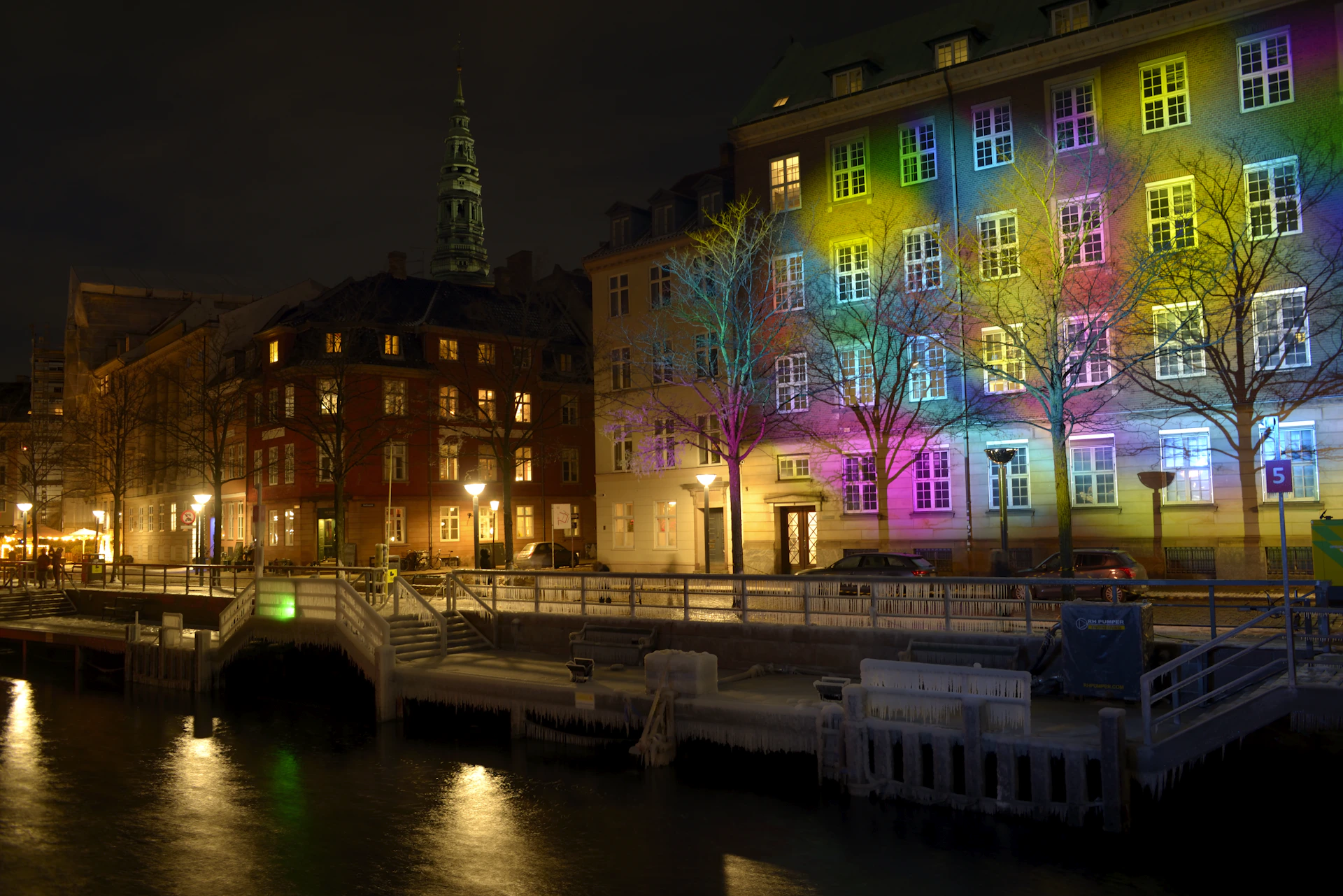 Colorful lights illuminate building facade at night