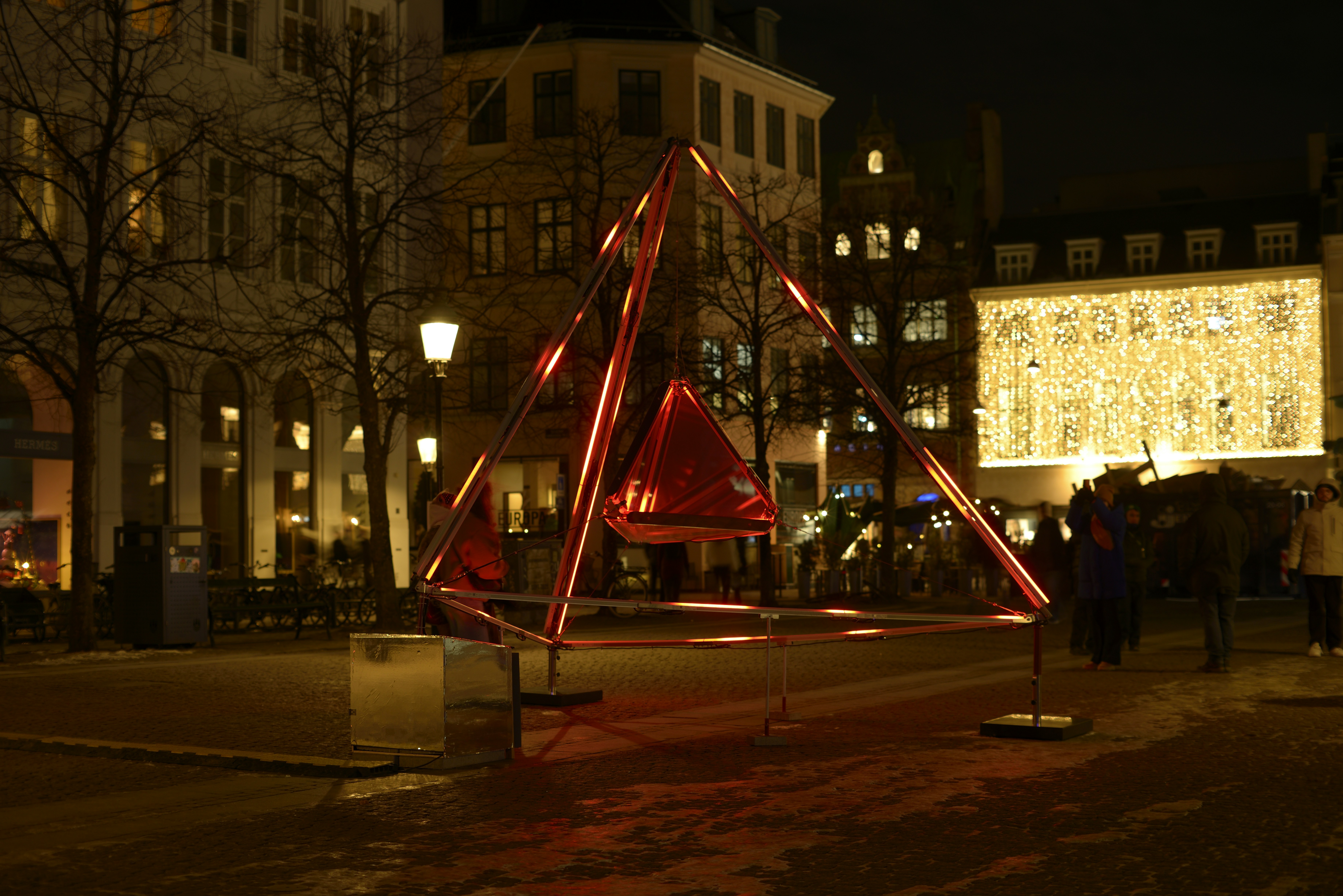 Mani Nikel – Denmark This is a geometric light sculpture composed of an illuminated inner tetrahedron – a four-sided pyramid, enclosing a mirrored form. As viewers move around the work, their perception changes. The light gradually changes, creating reflections that multiply the space and fragment the mirrored images. Copenhagen Light Festival is an annual light festival that transforms the quiet and cold winter darkness into a unique celebration of light art, lighting design and illumination in the center of Copenhagen.
