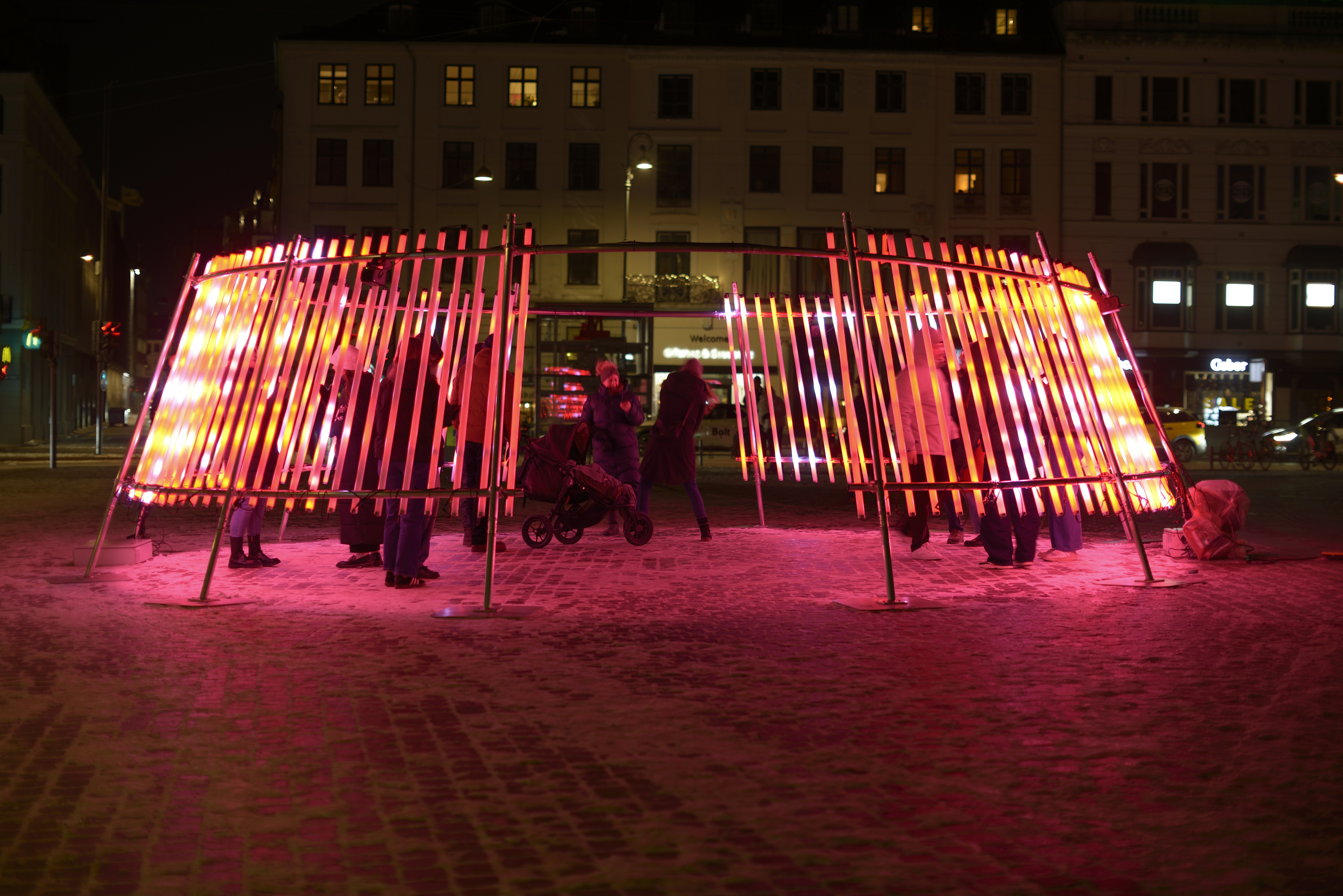 Illuminated structure with people at night