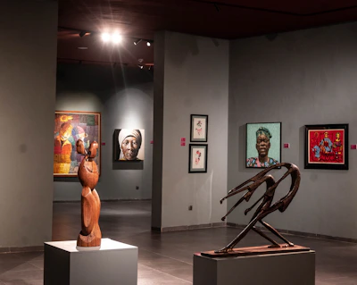 Sculptures and paintings displayed in a museum gallery.