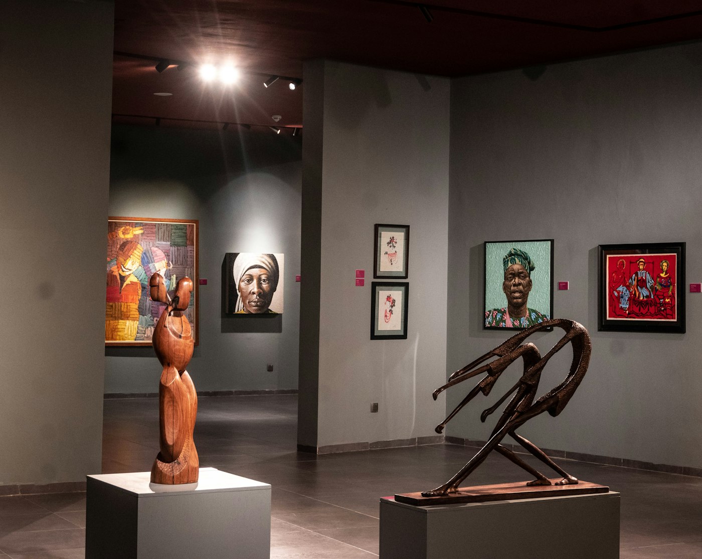 Sculptures and paintings by African artists displayed in a museum gallery