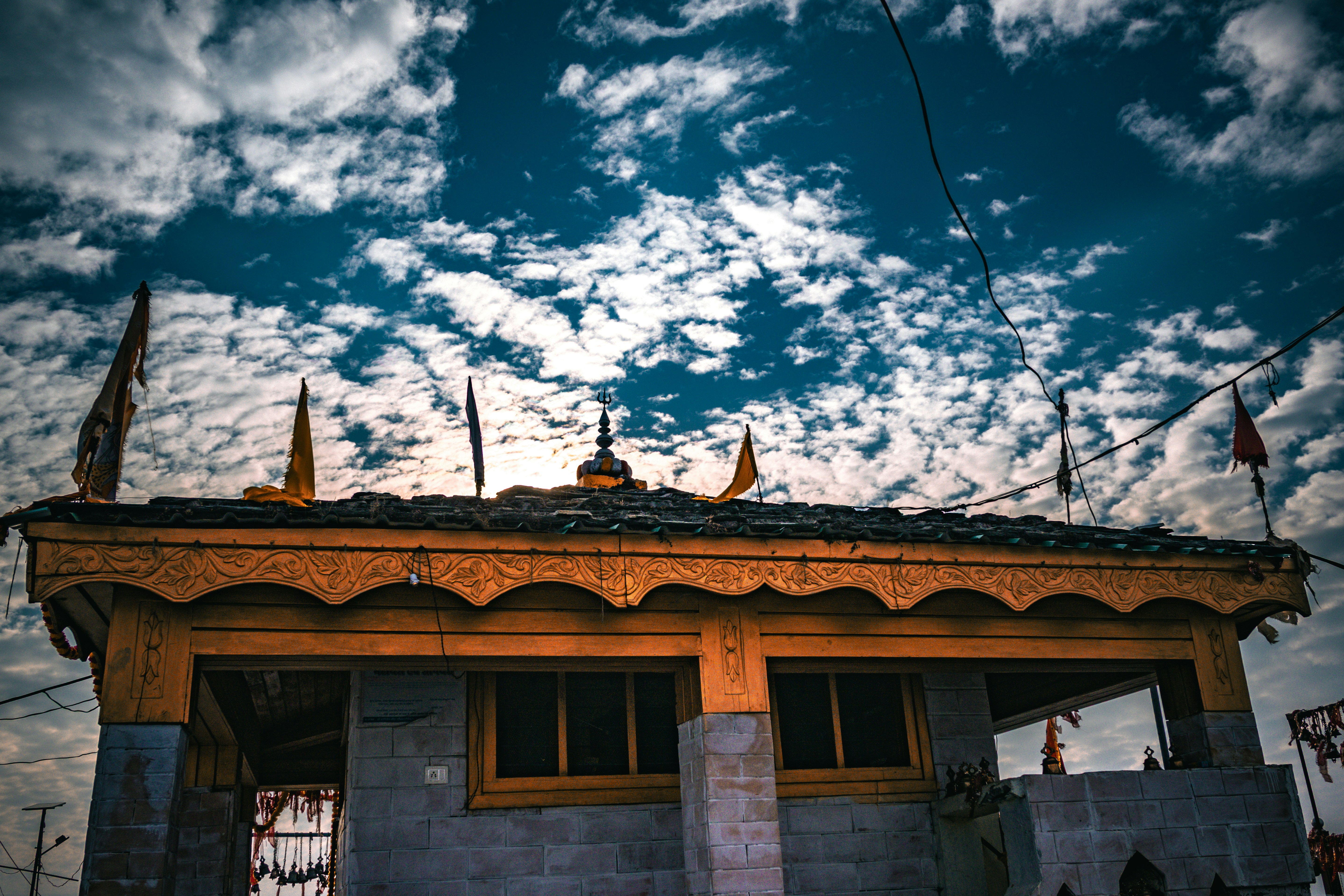 A building with flags under a cloudy sky